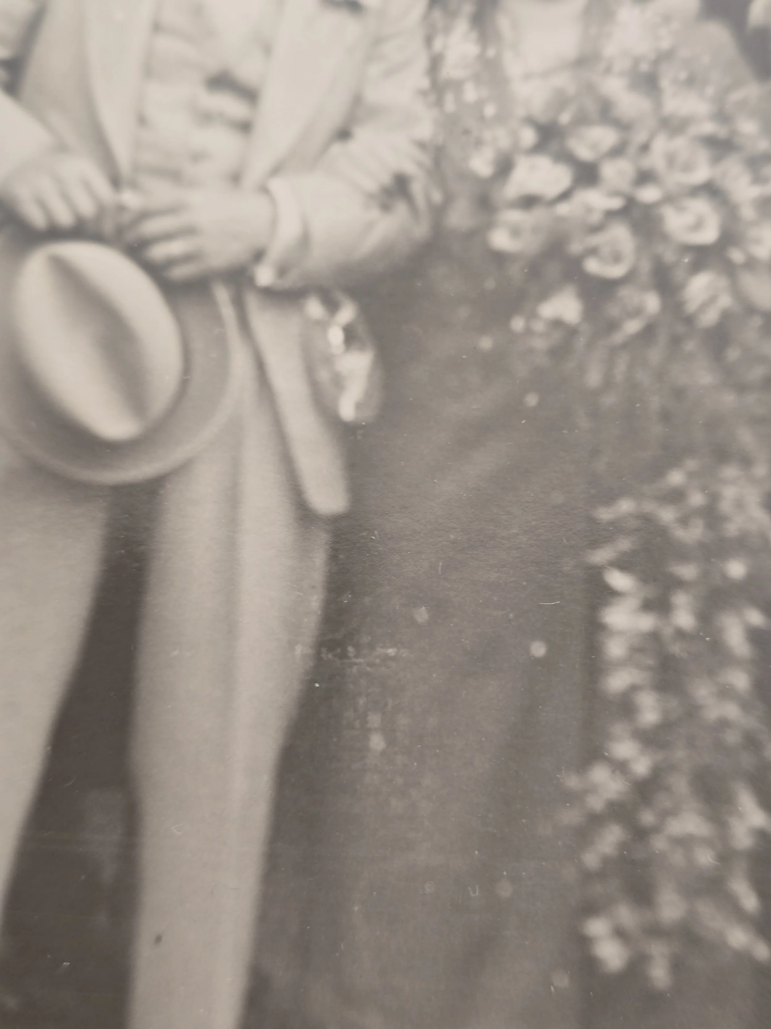 Close-up showing the softly faded surface and age-related marks of an original 1930s photograph.