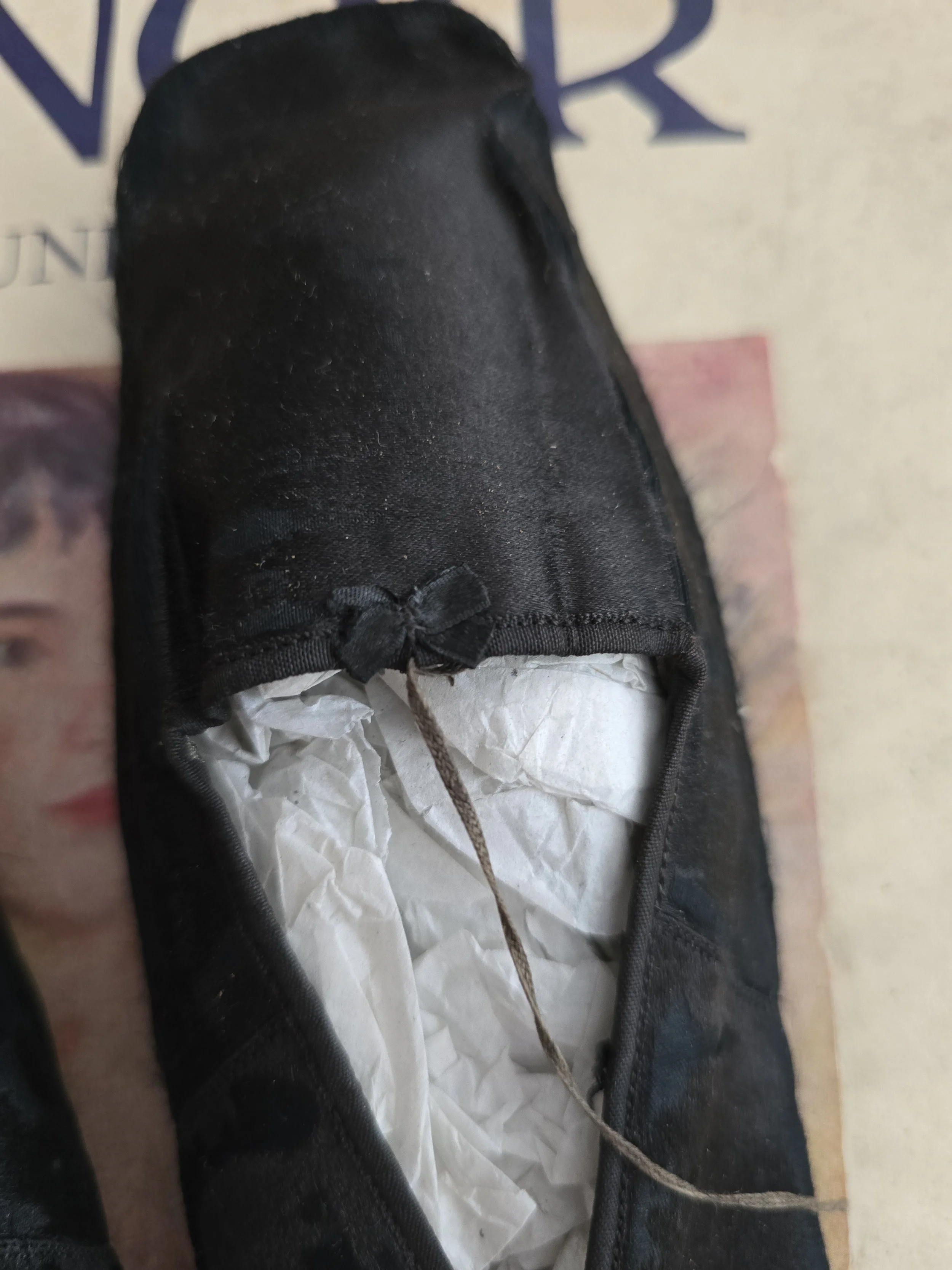 Close up of original black silk ribbon ankle ties.