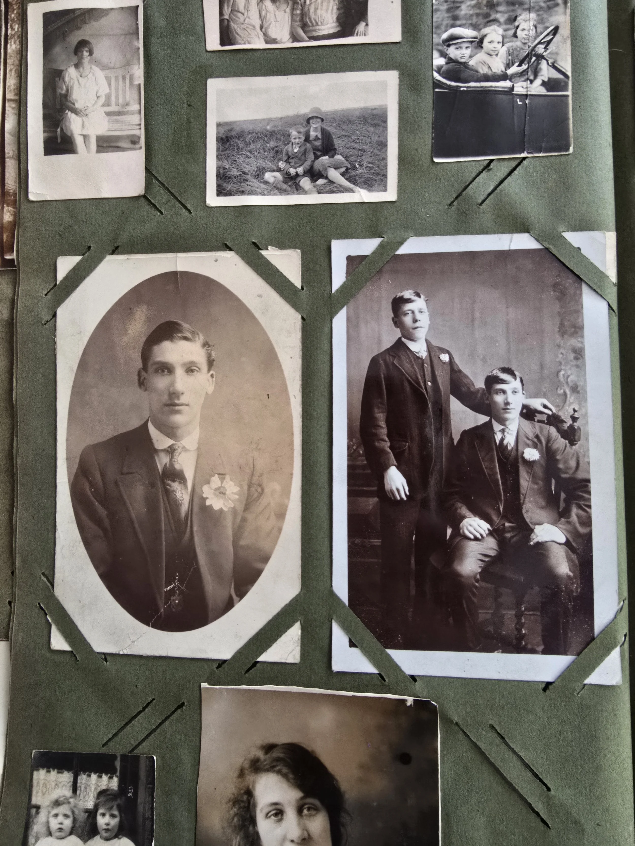 Vintage photo album page with two young men in suits, early 20th century portraits