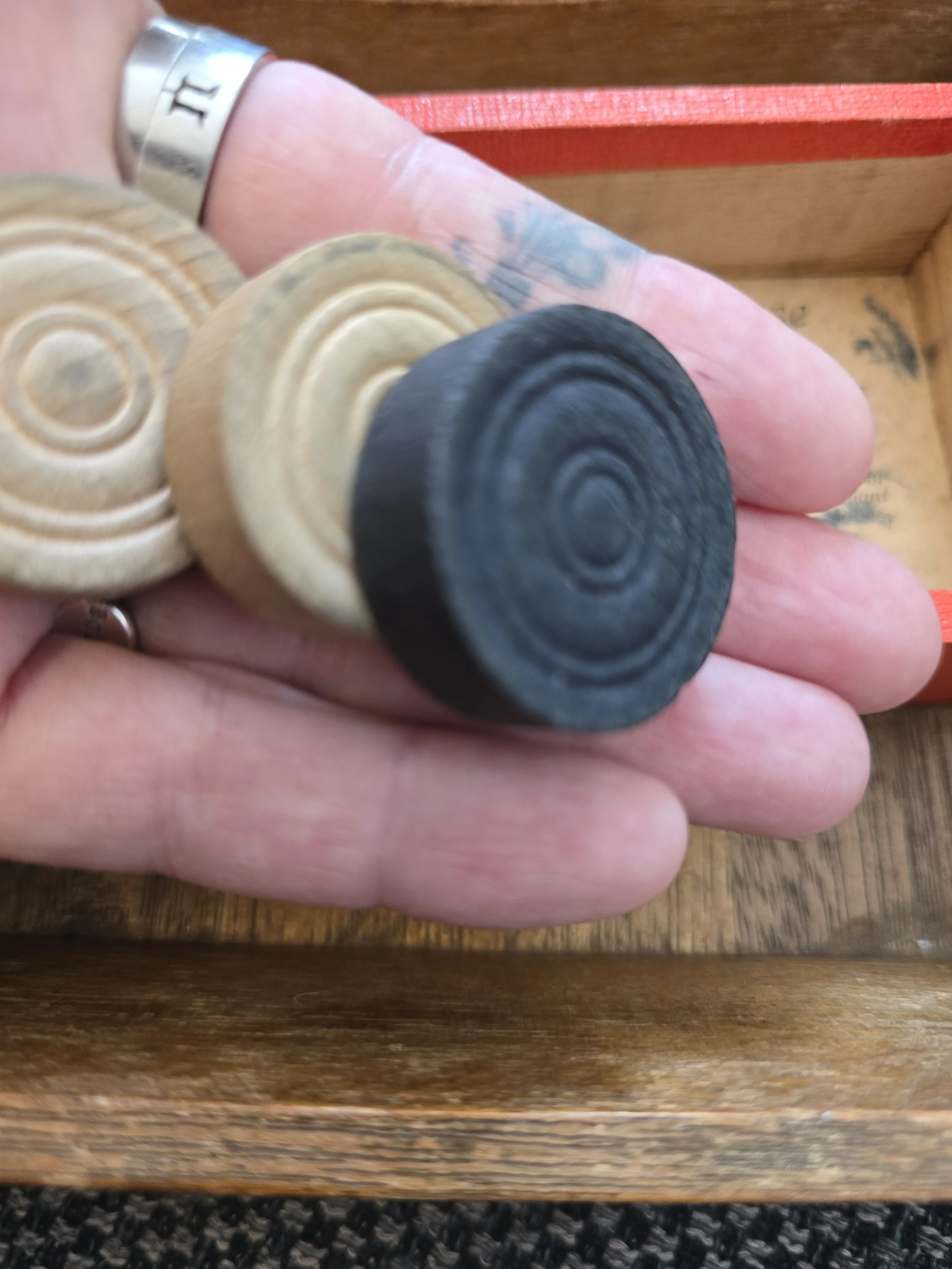 black and natural wooden draughts counters