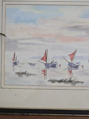 Angled framed view of 1980s Downderry Beach watercolour, boats with red sails on calm sea, vintage coastal art