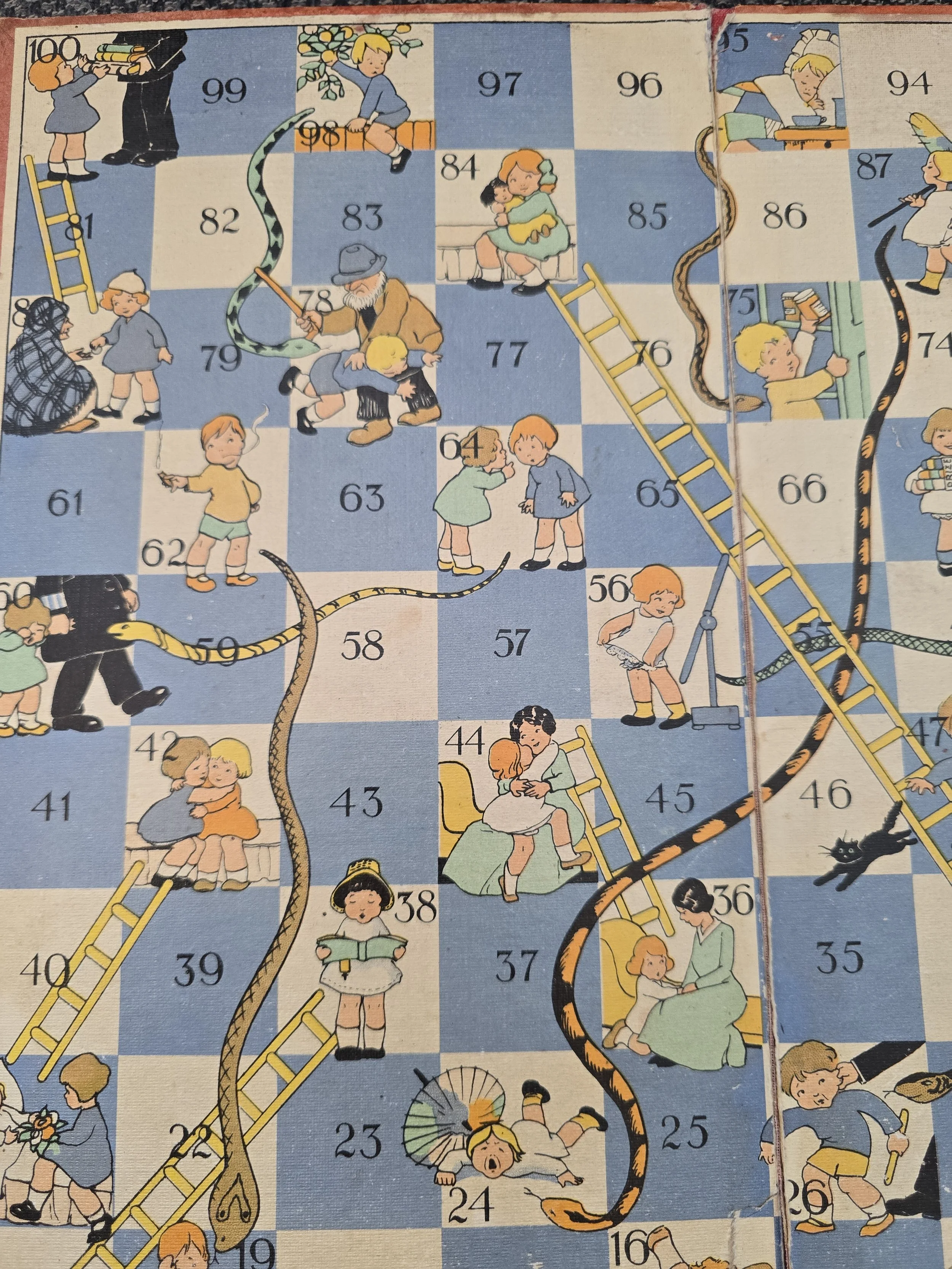 Timeworn English Snakes and Ladders board illustrated with children