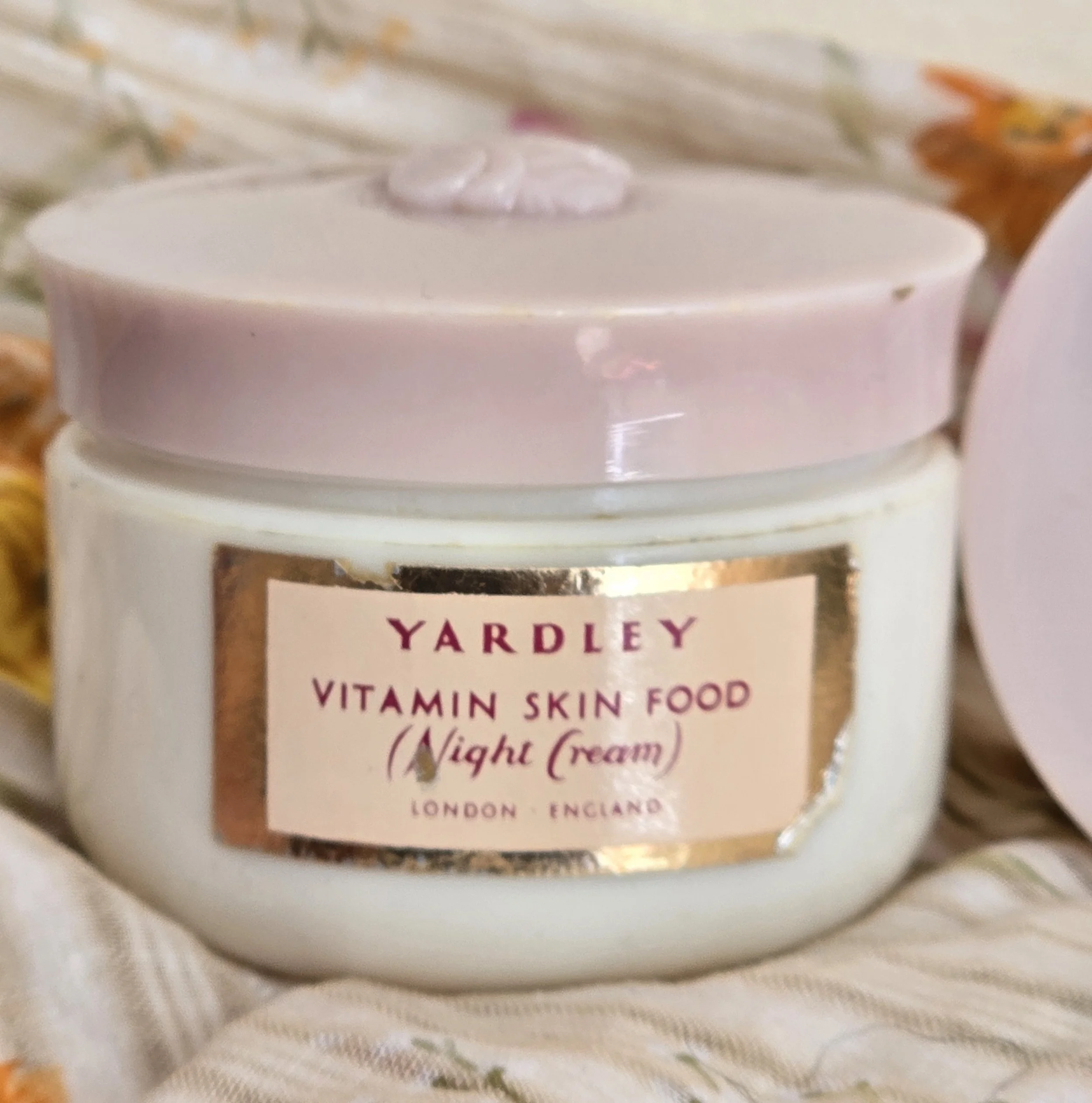 Yardley night cream jar standing upright against soft floral cloth