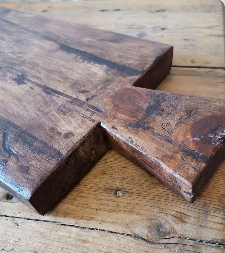Full view of French vintage oak cutting board with sculptural handle on wooden table