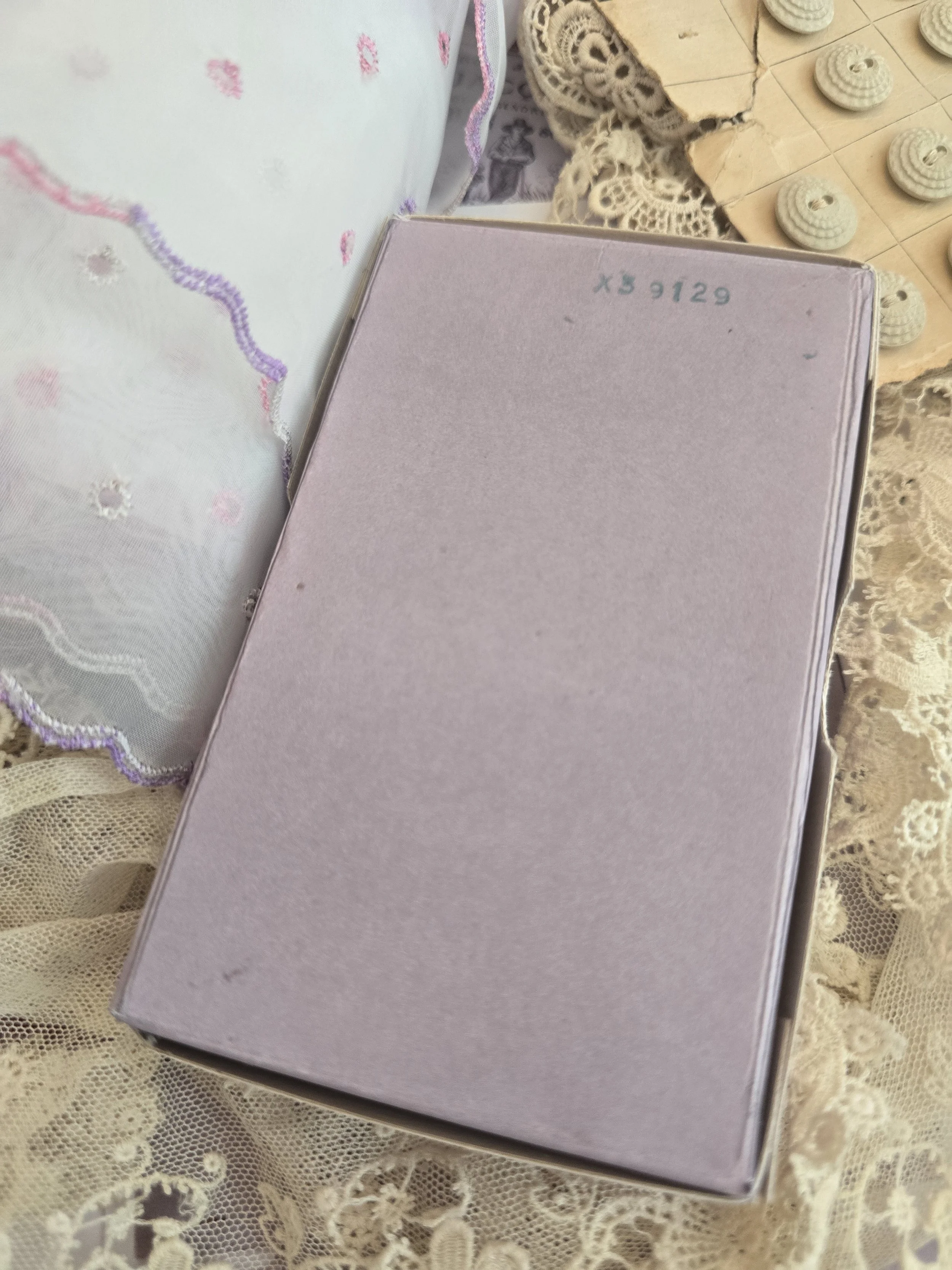 Underside of the handmade blush pink box constructed from vintage French card stock.