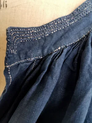 White stitch pleats on shoulder of French indigo linen smock.