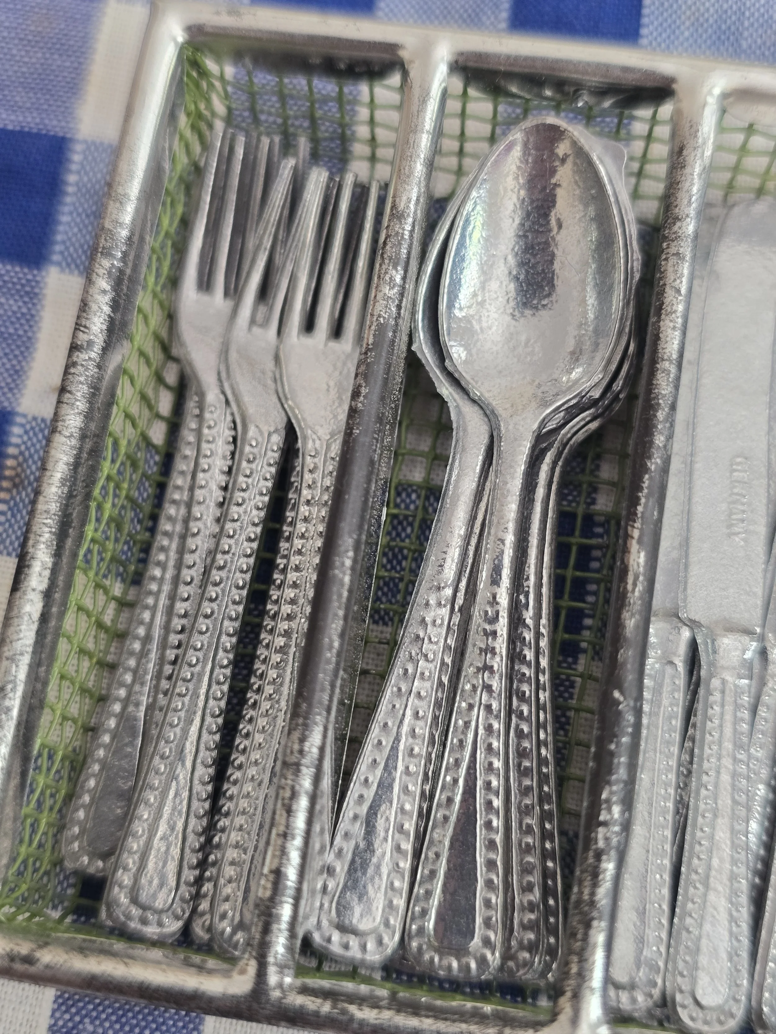 Close-up of vintage miniature forks and spoons.