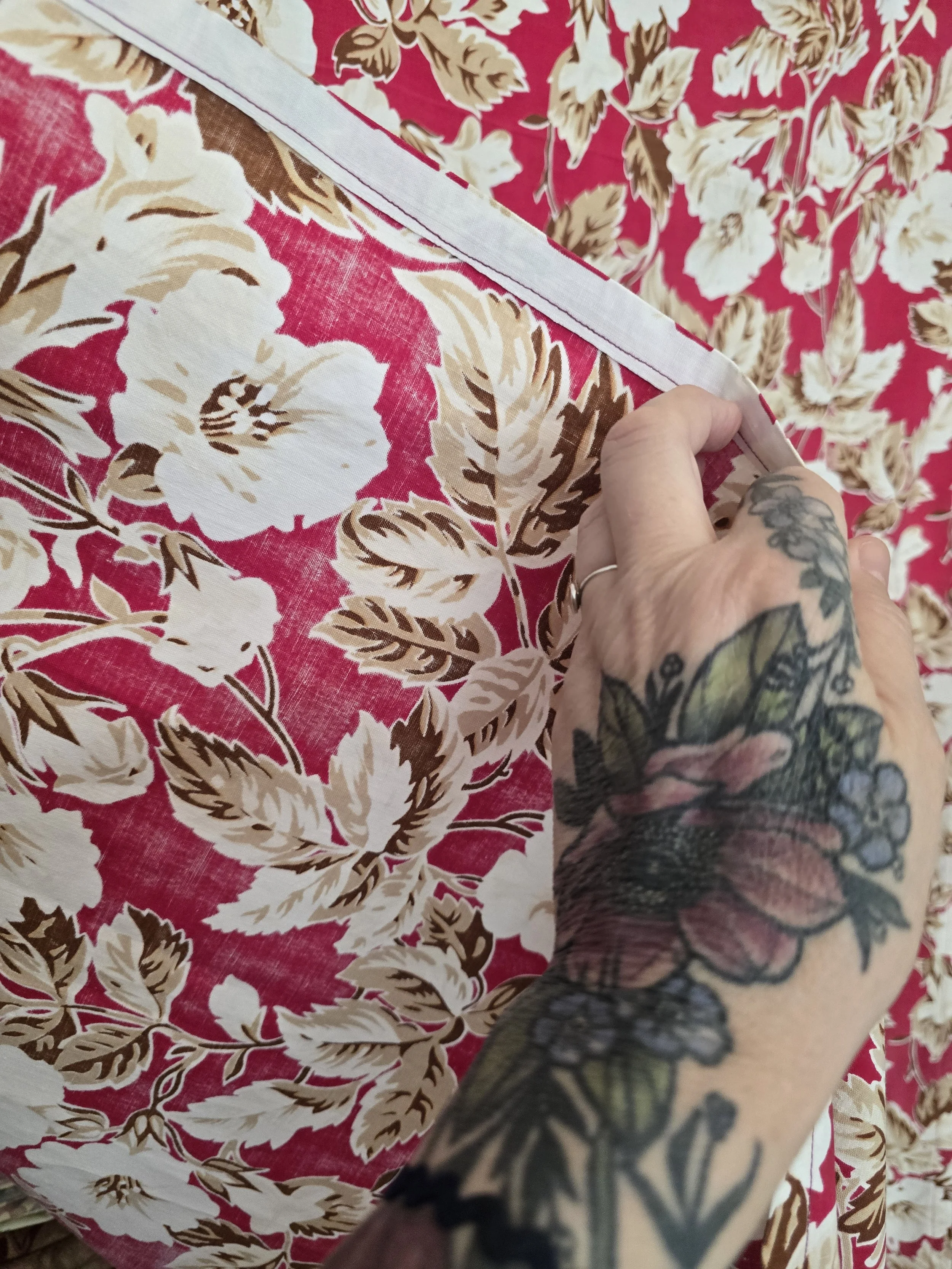 Vintage pink floral fabric photographed with selvedge edge detail