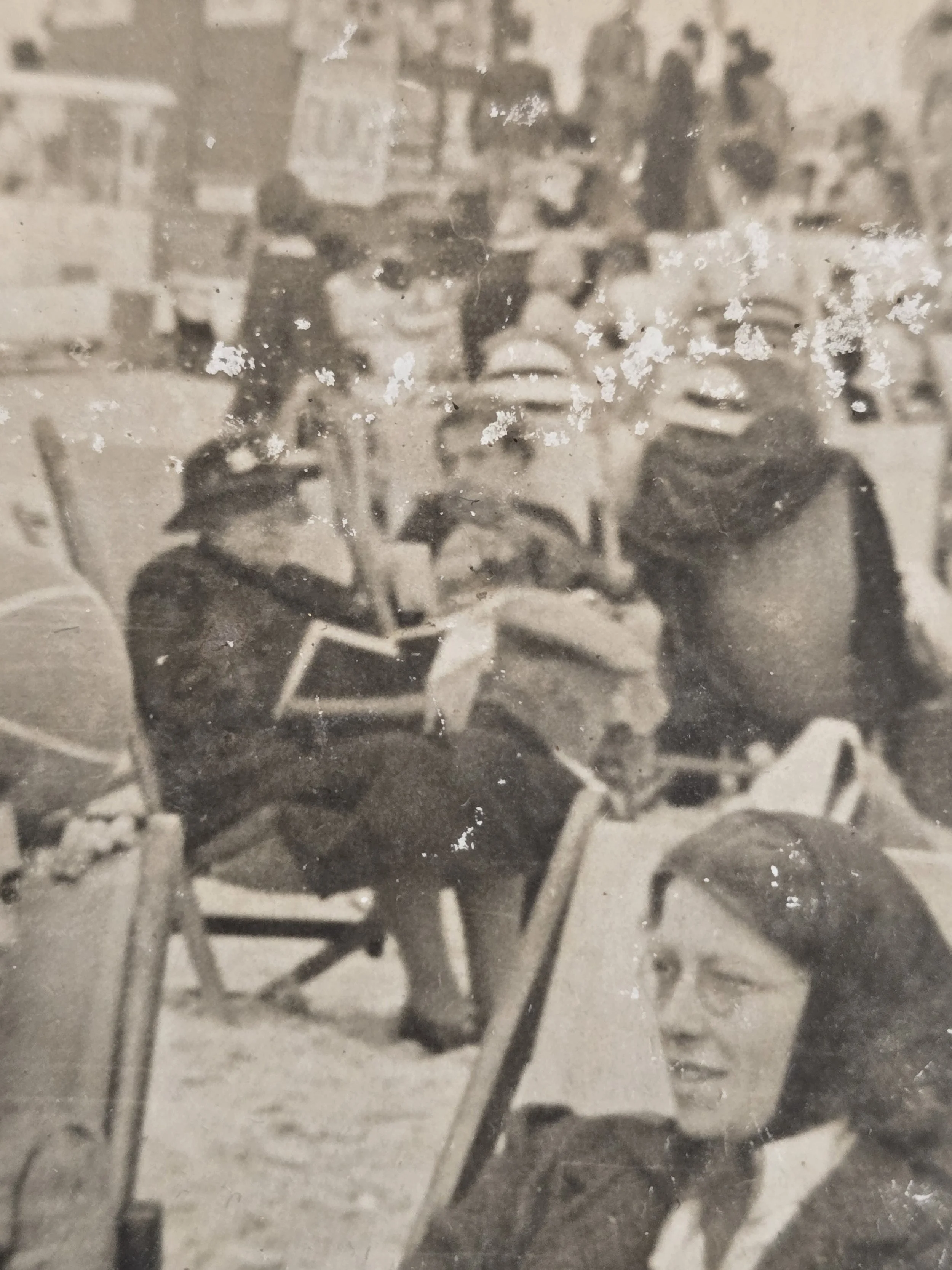 Detail of holidaymakers and rows of deckchairs in an original pre-war or wartime era British beach photograph.