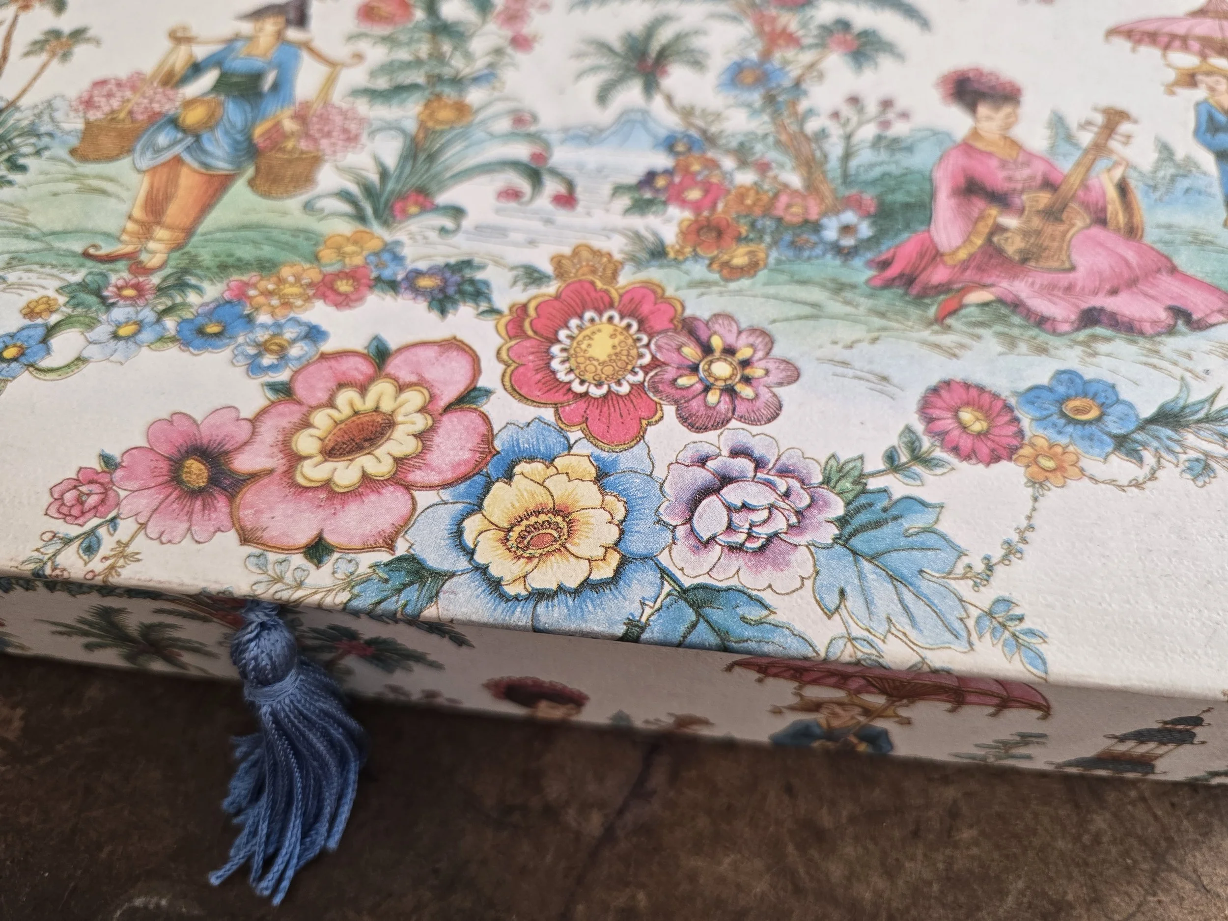 Detail of colourful floral and figure decoration on vintage Waverley writing box