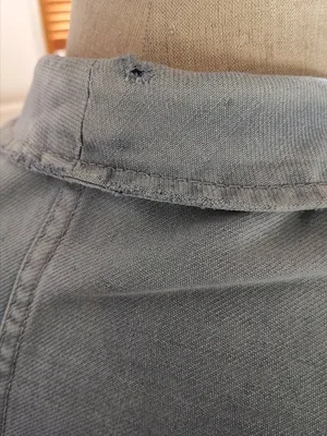 Frayed cuff with original button on vintage chore jacket