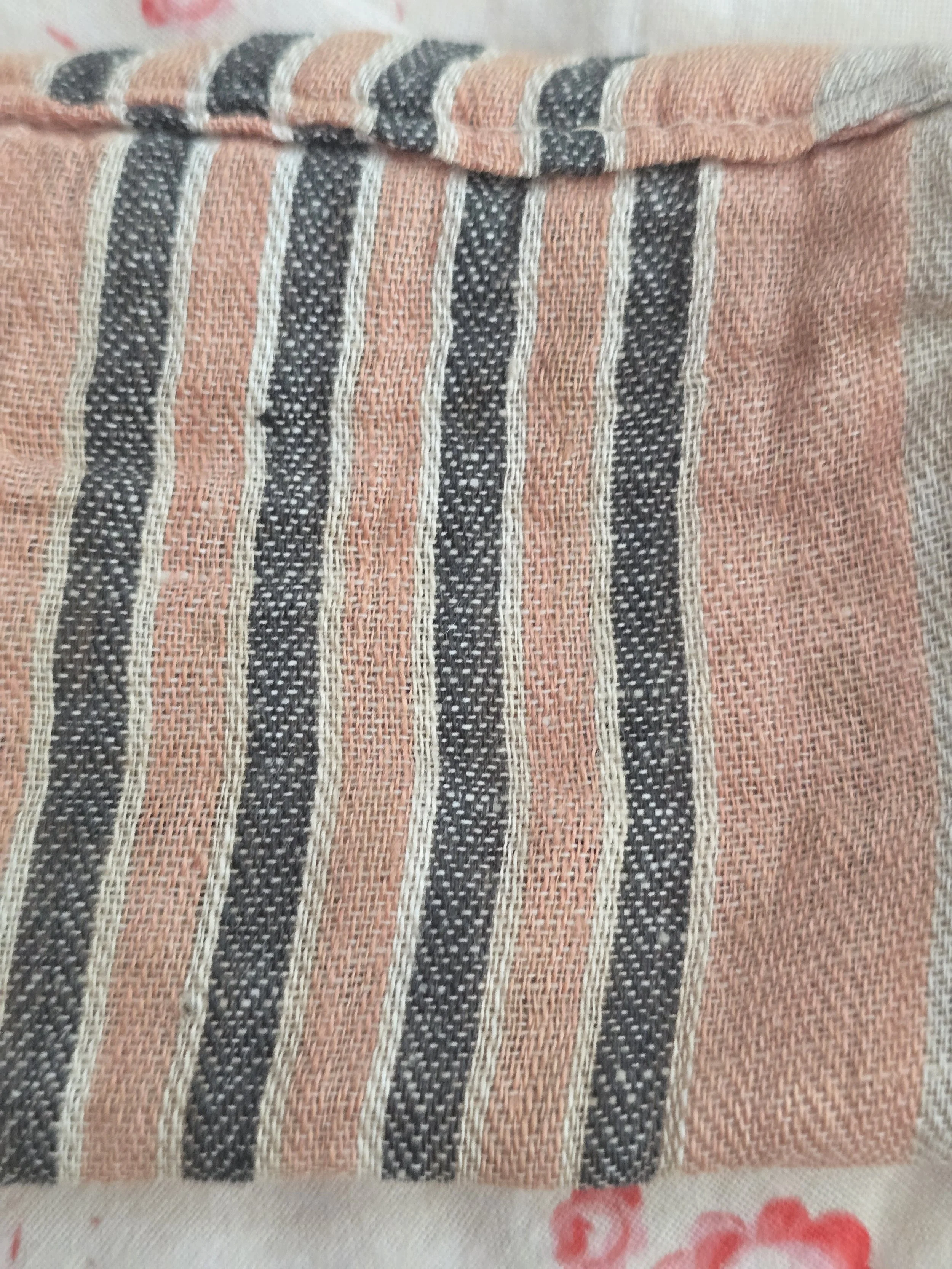 Faded pink and charcoal ticking fabric pillow.