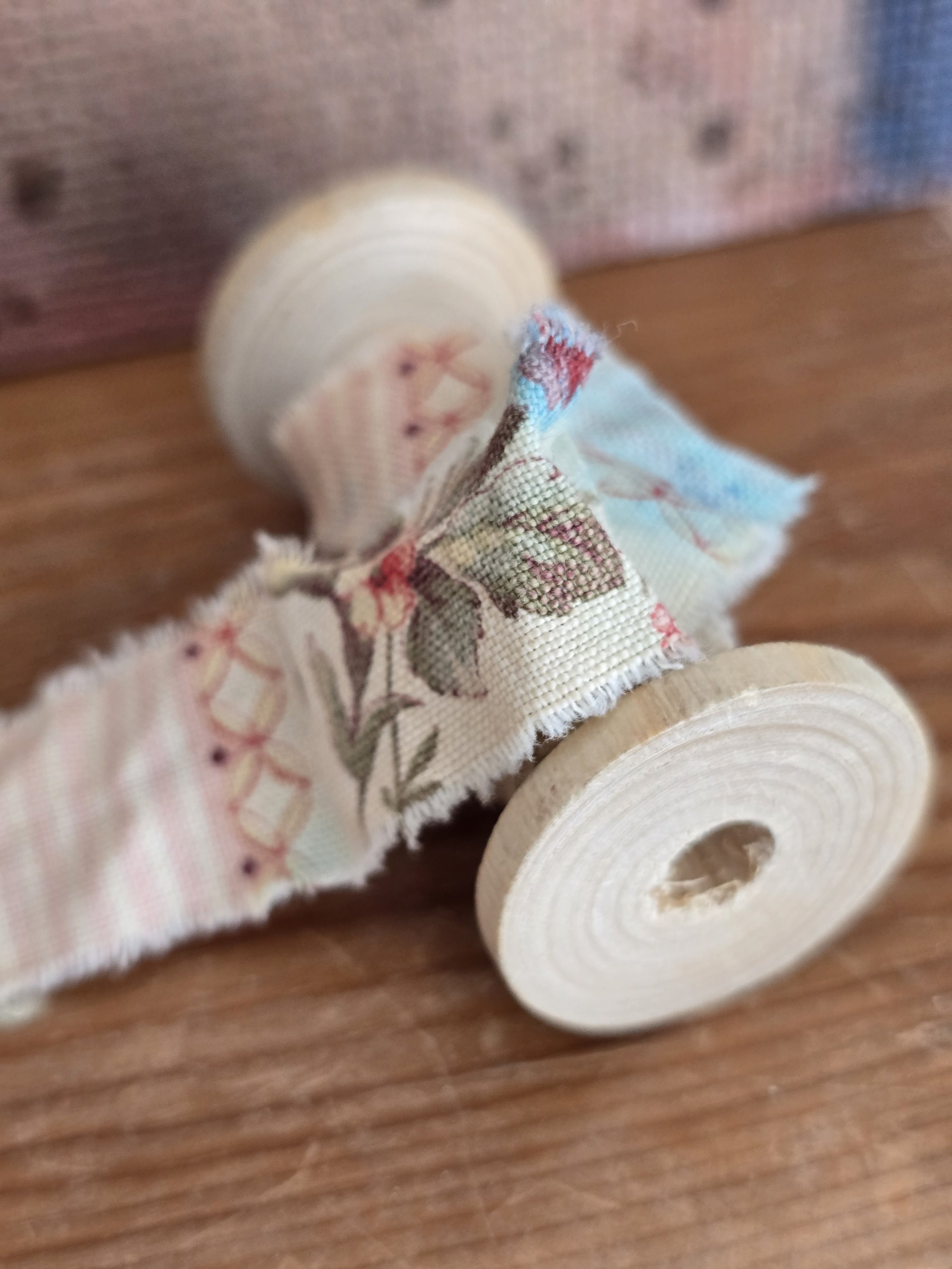 Antique french floral fabric trim on wooden spool
