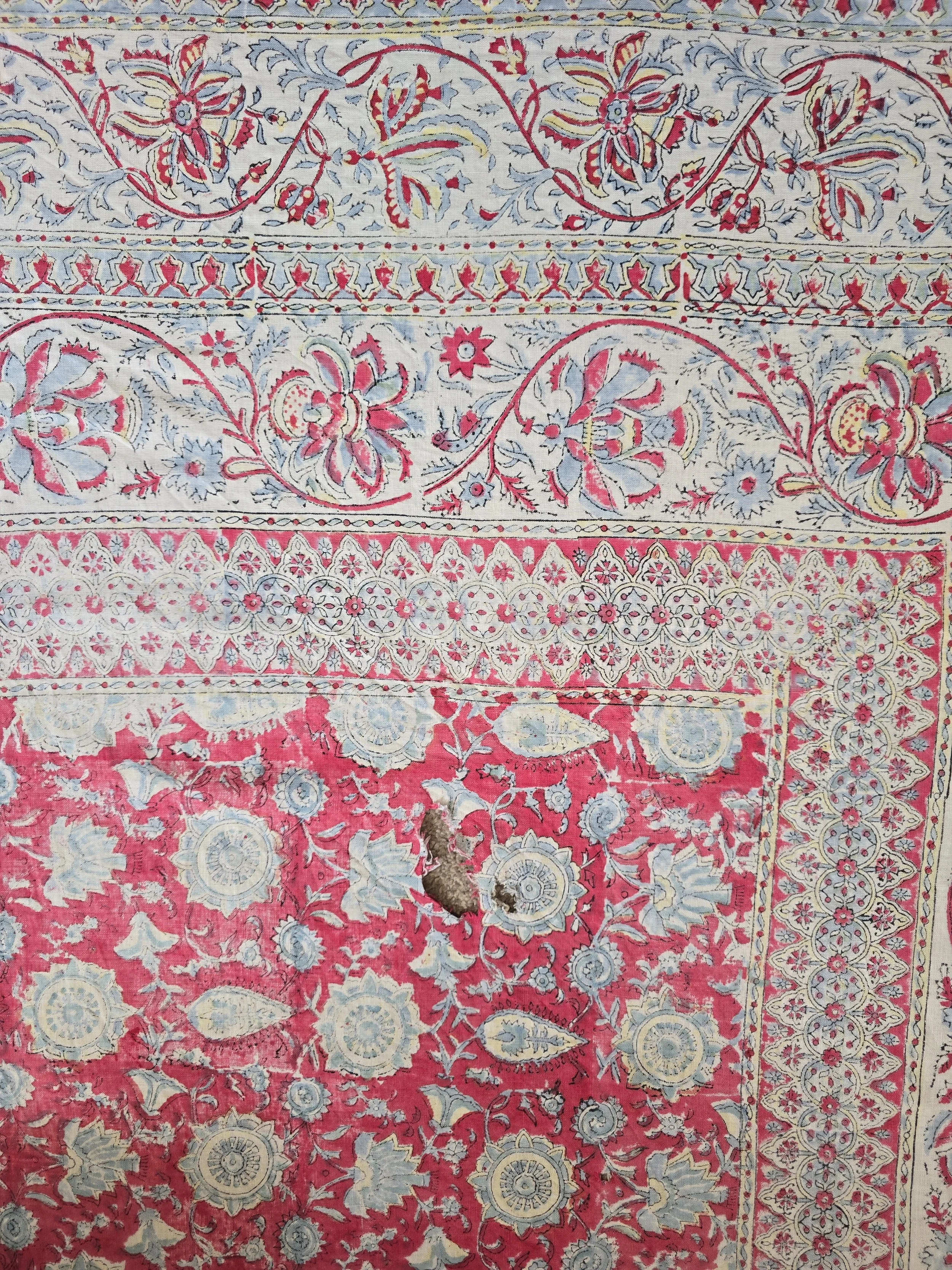 Faded vintage cotton fabric with red ground
