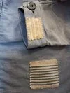 Sleeve with visible mending and sashiko stitches on vintage French workwear coat.
