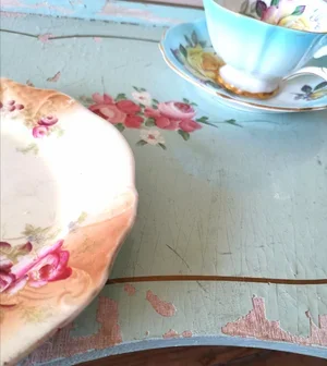 Close-up of French 1920s folding tray with pale blue paint and hand-painted roses