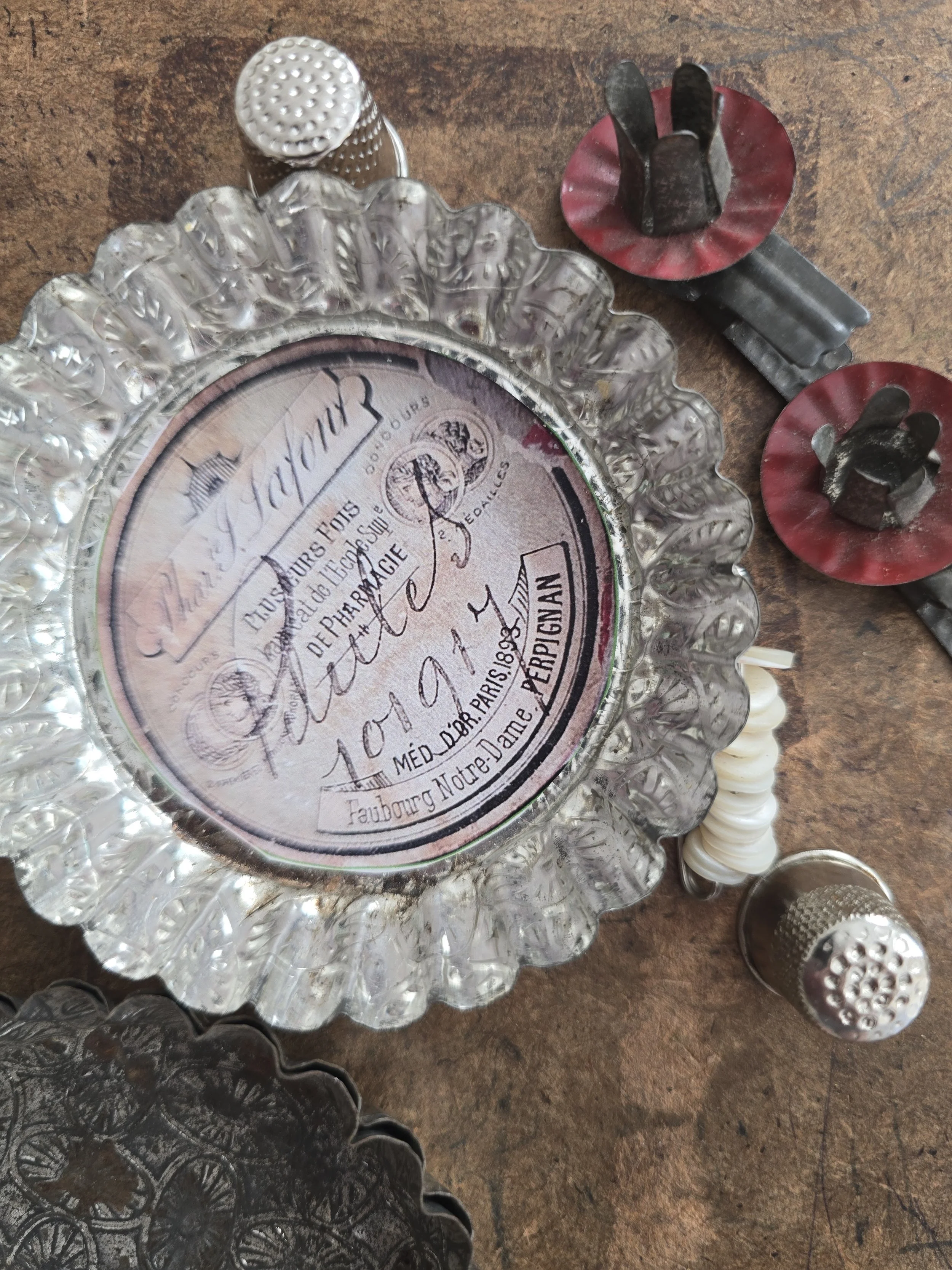 Studio-made needle keep in a vintage French metal pastry mould with 1893 pharmacy label