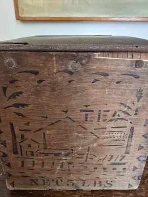 Textured corner of crate showing rusted lid edge and timeworn wood