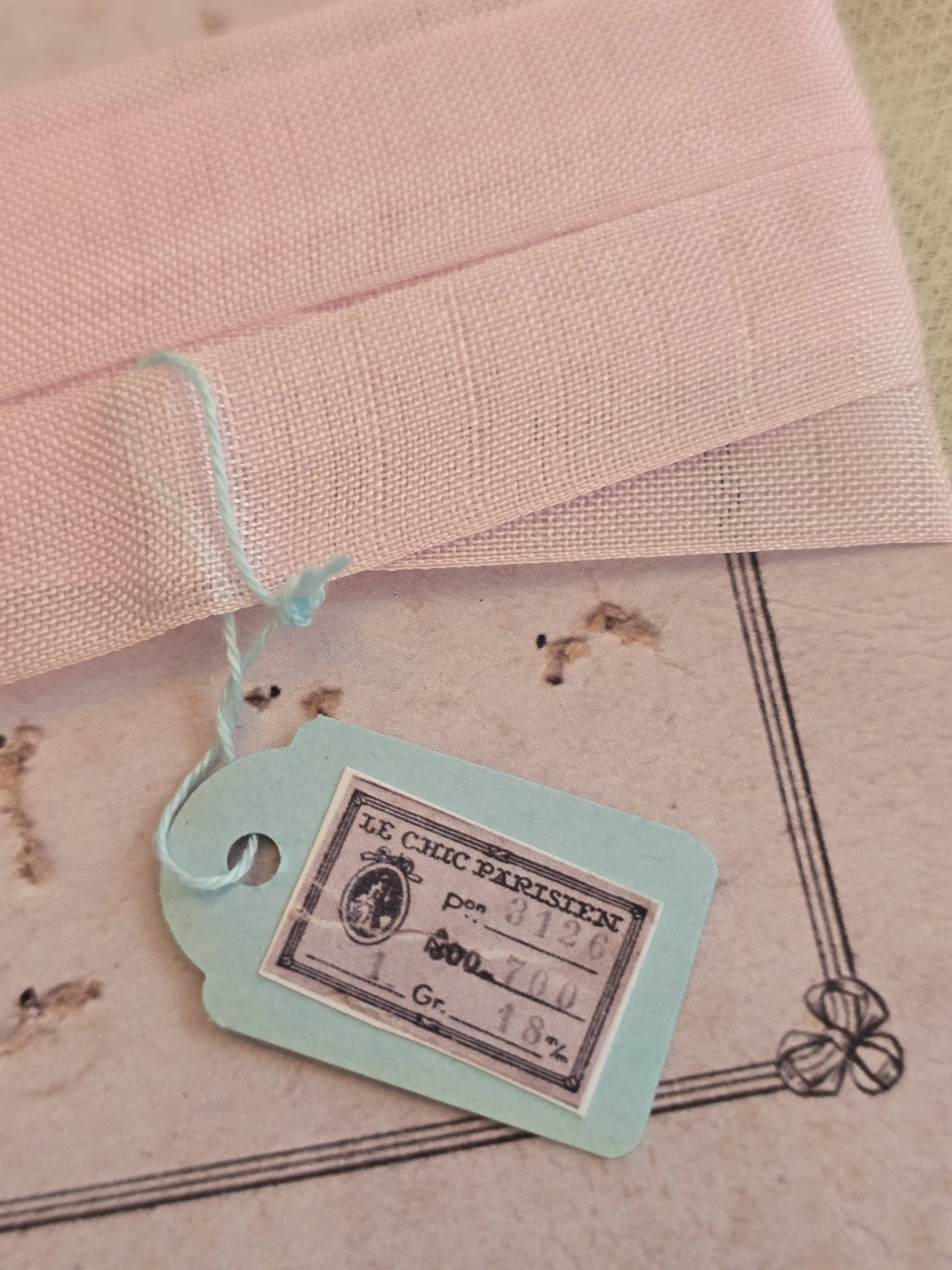 Powder pink vintage French ribbon wound around a decorative Chic haberdashery card.