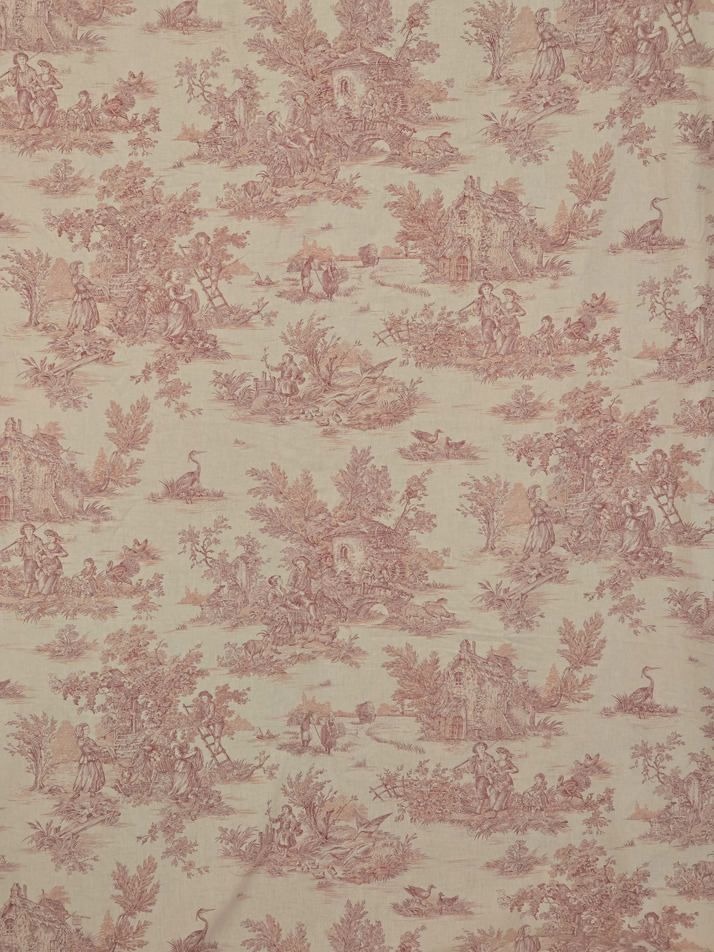Large length of French MFTA Pastorale cotton fabric with raspberry red pastoral scenes on a warm cream ground.