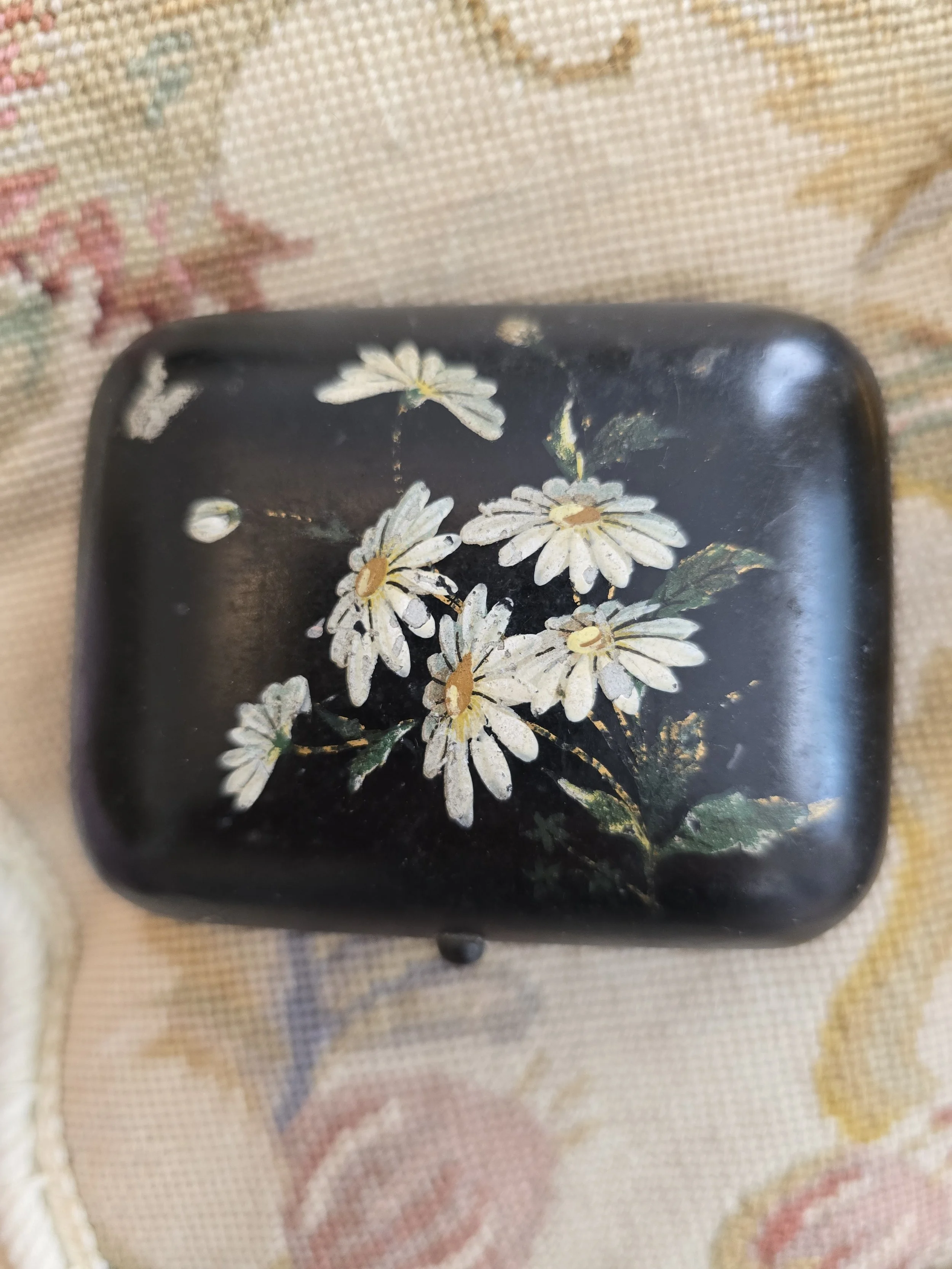 Vintage black trinket box with hand-painted white daisies on the lid