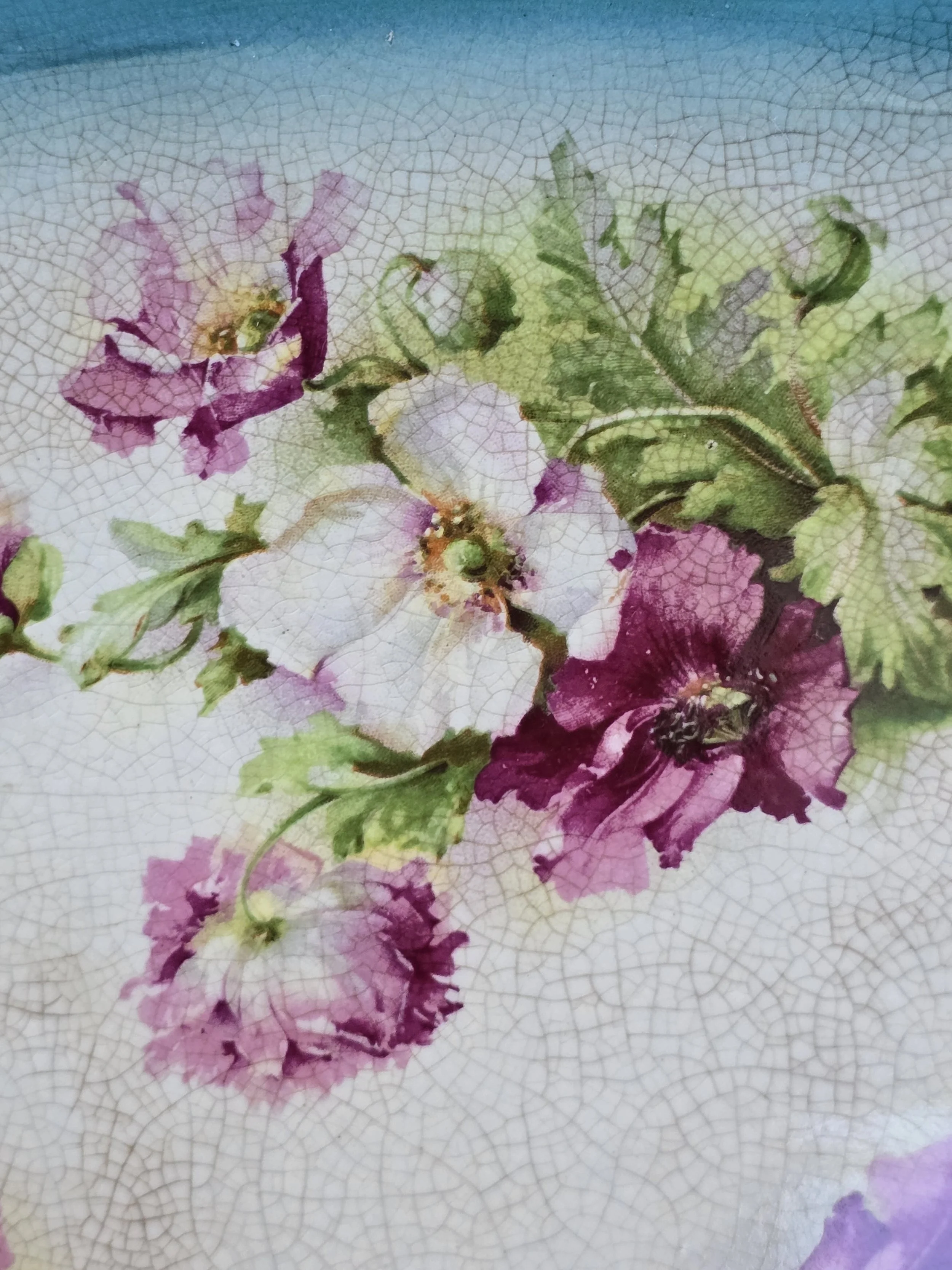 Reverse of vintage ceramic tray showing crazed glaze, discolouration and traces of green colour.