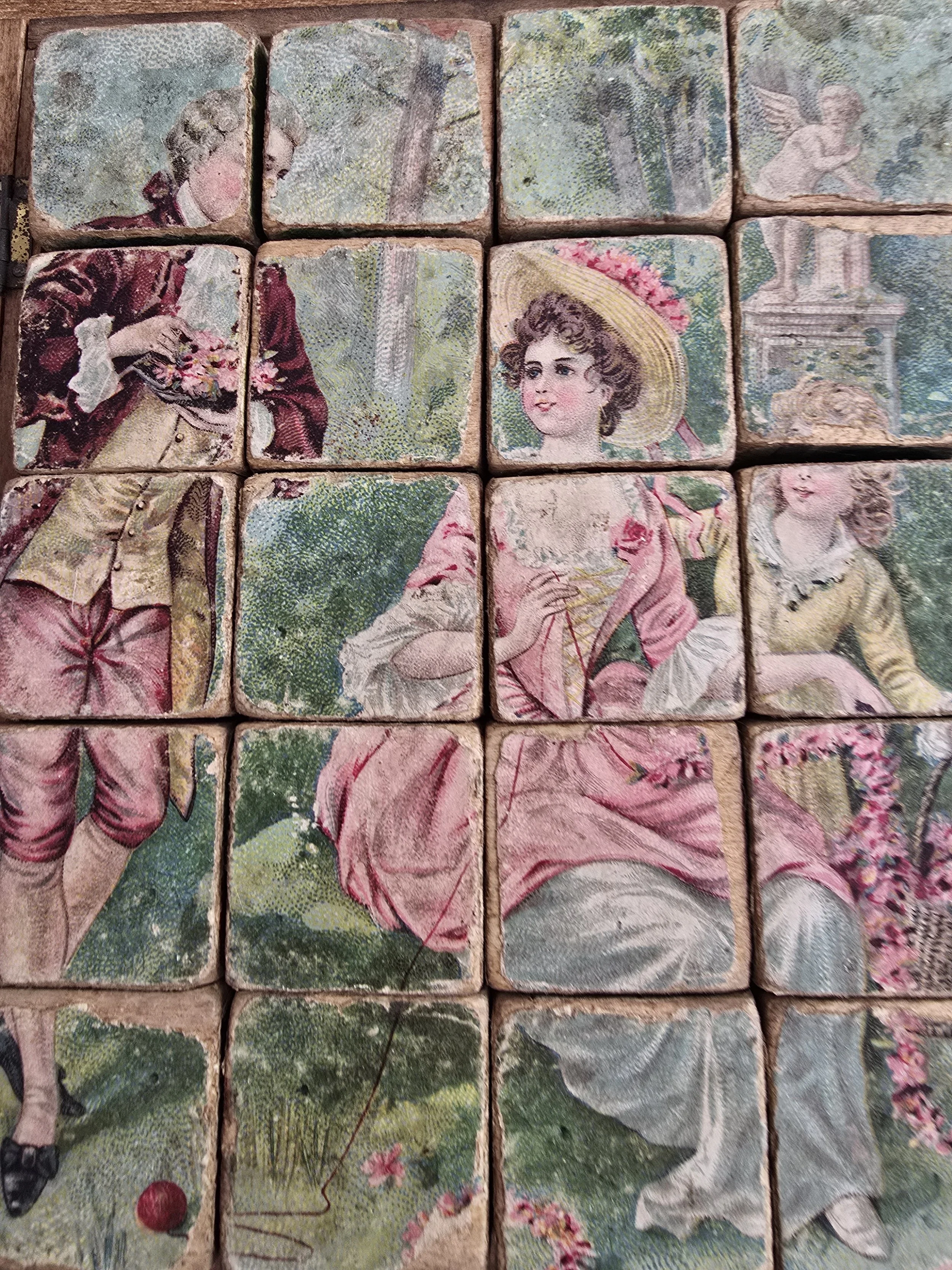close up of worn vintage wooden blocks with faded children illustrations