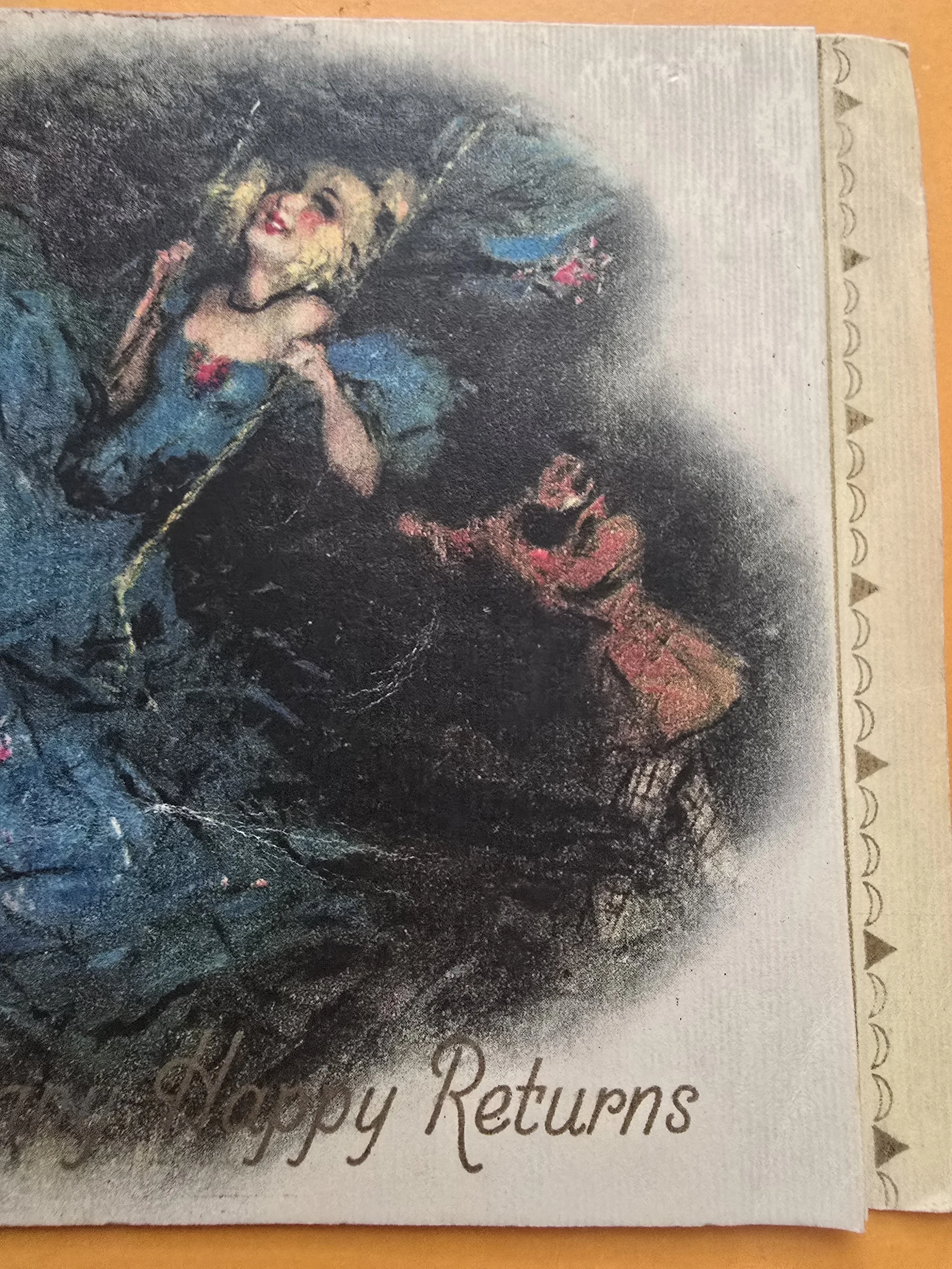 Full front view of vintage Tuck’s birthday card with blonde glamour girl in a blue gown swinging, captioned “Many Happy Returns”