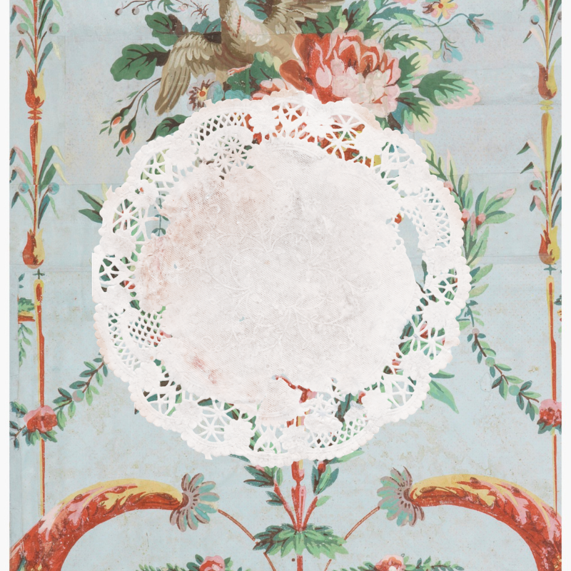Damaged vintage lace doily laid over the 18th-century French Les Deux Pigeons wallpaper design.