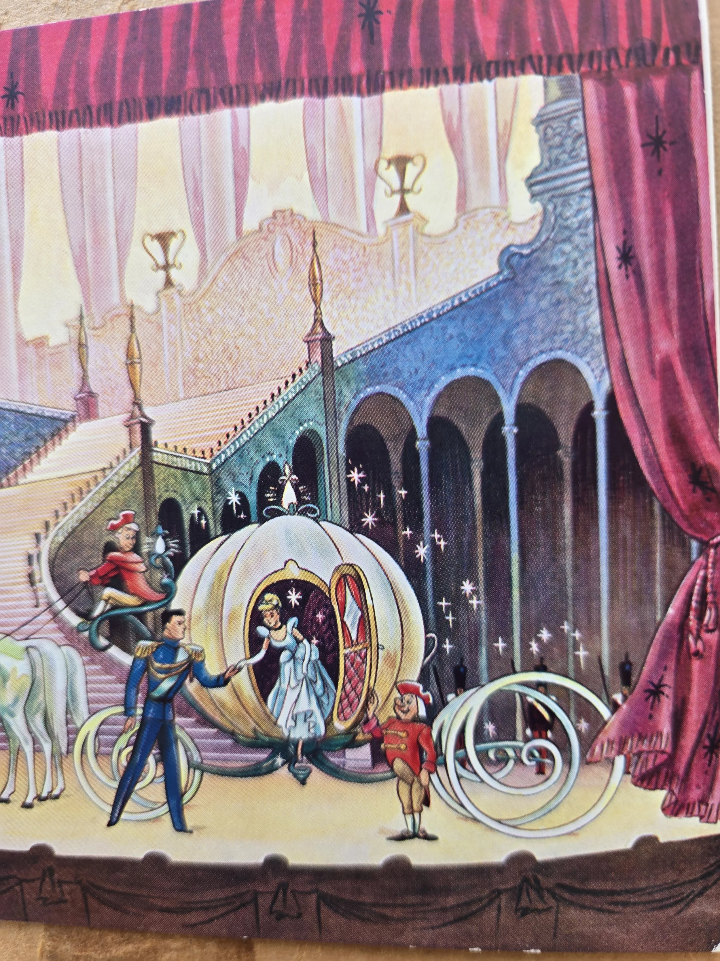 Colourful vintage Cinderella Christmas card framed by red theatre curtains