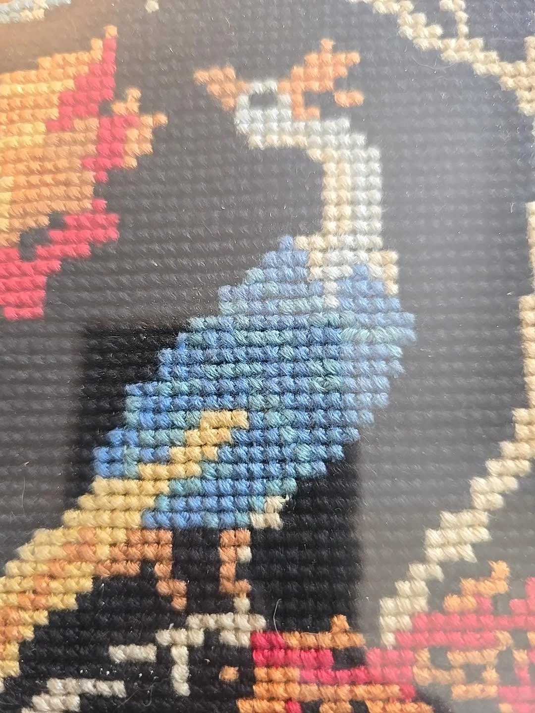 Old paper backing and hanging cord on vintage framed peacock needlework