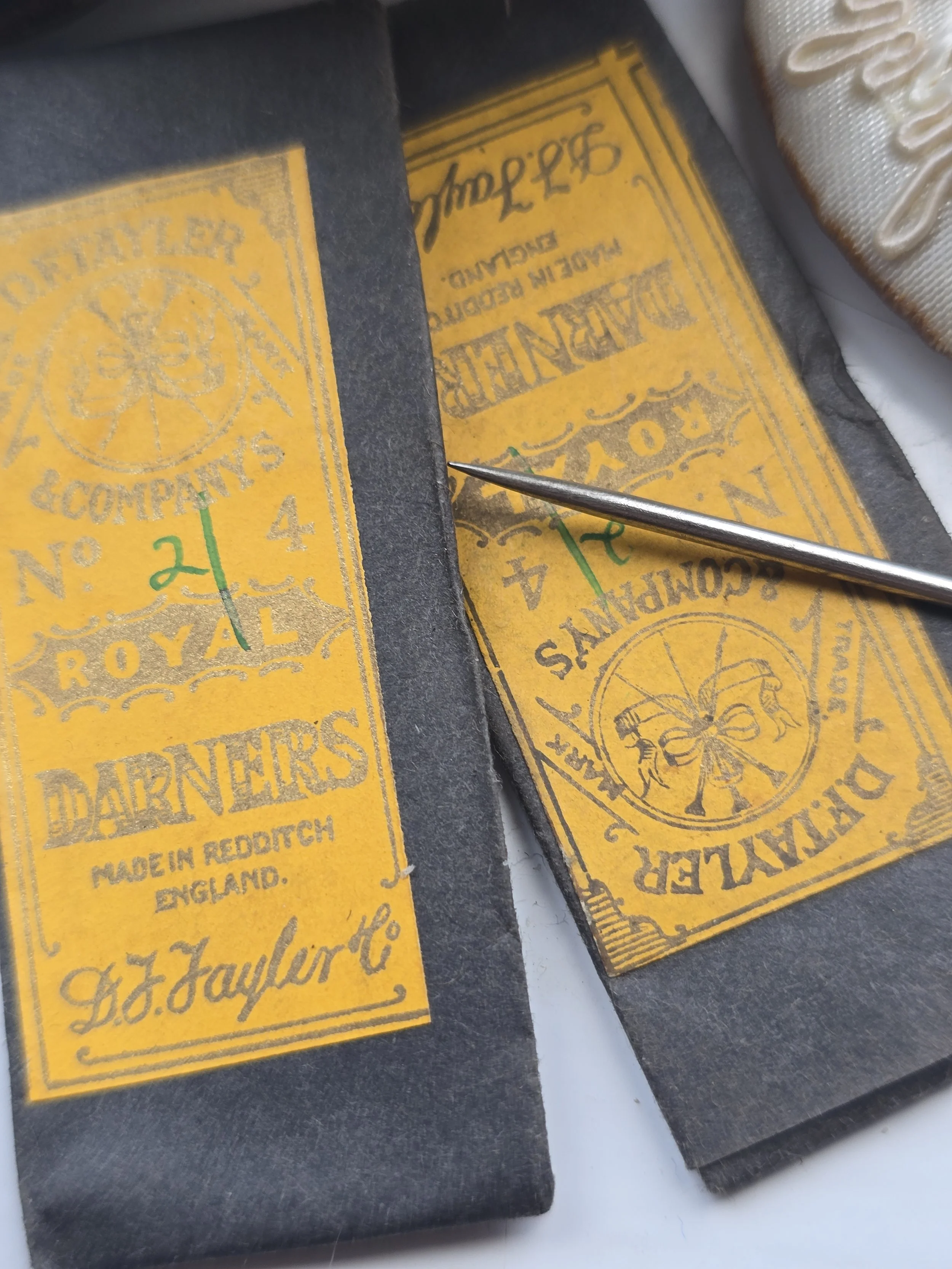 Close-up of an original Royal Darners No. 24 needle packet, a collectible piece of vintage Redditch needle-making history.