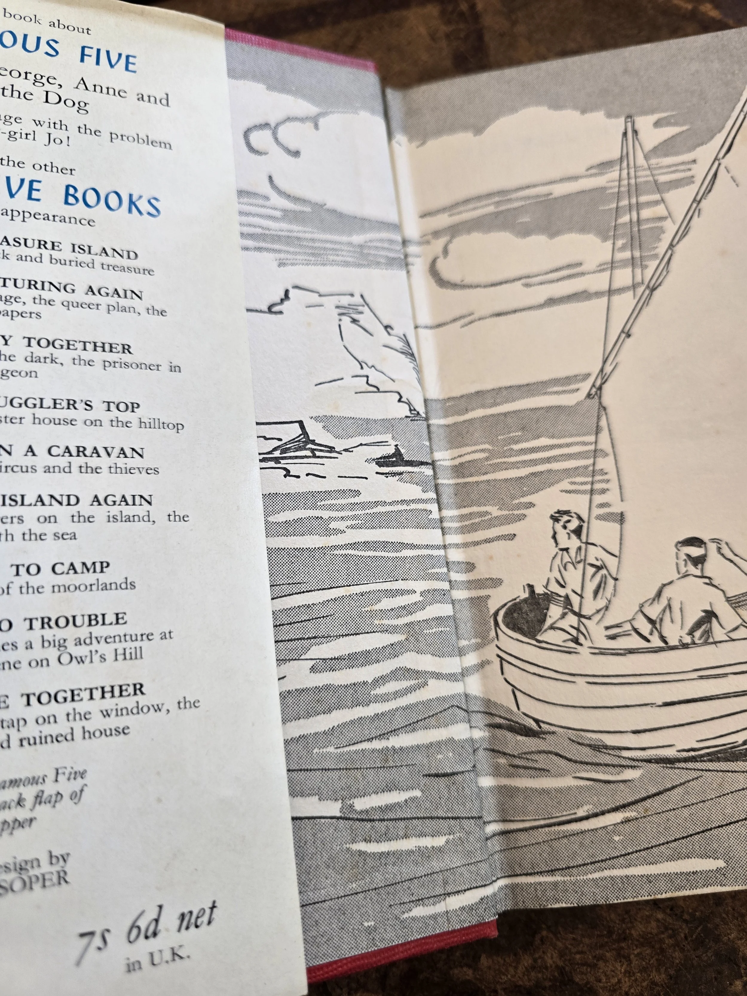 Decorative illustrated endpapers featuring a sailing scene from the Famous Five series.