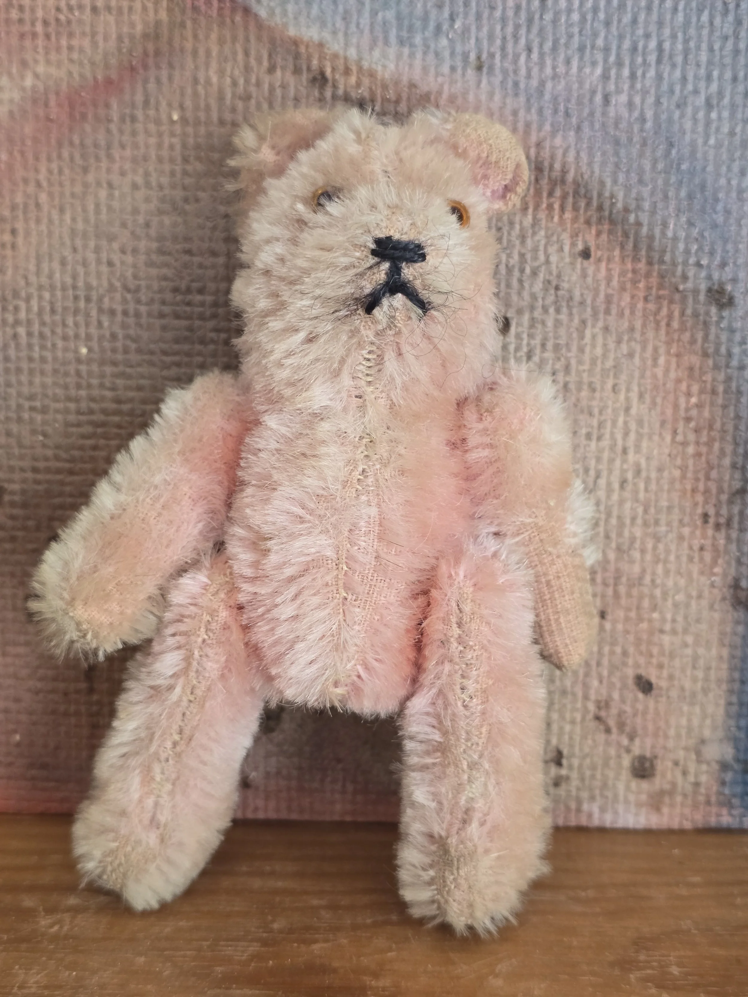 Tiny vintage pink teddy bear with glass eyes