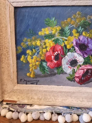 Detail of vibrant anemones in red, white, purple, and pink with mimosa flowers