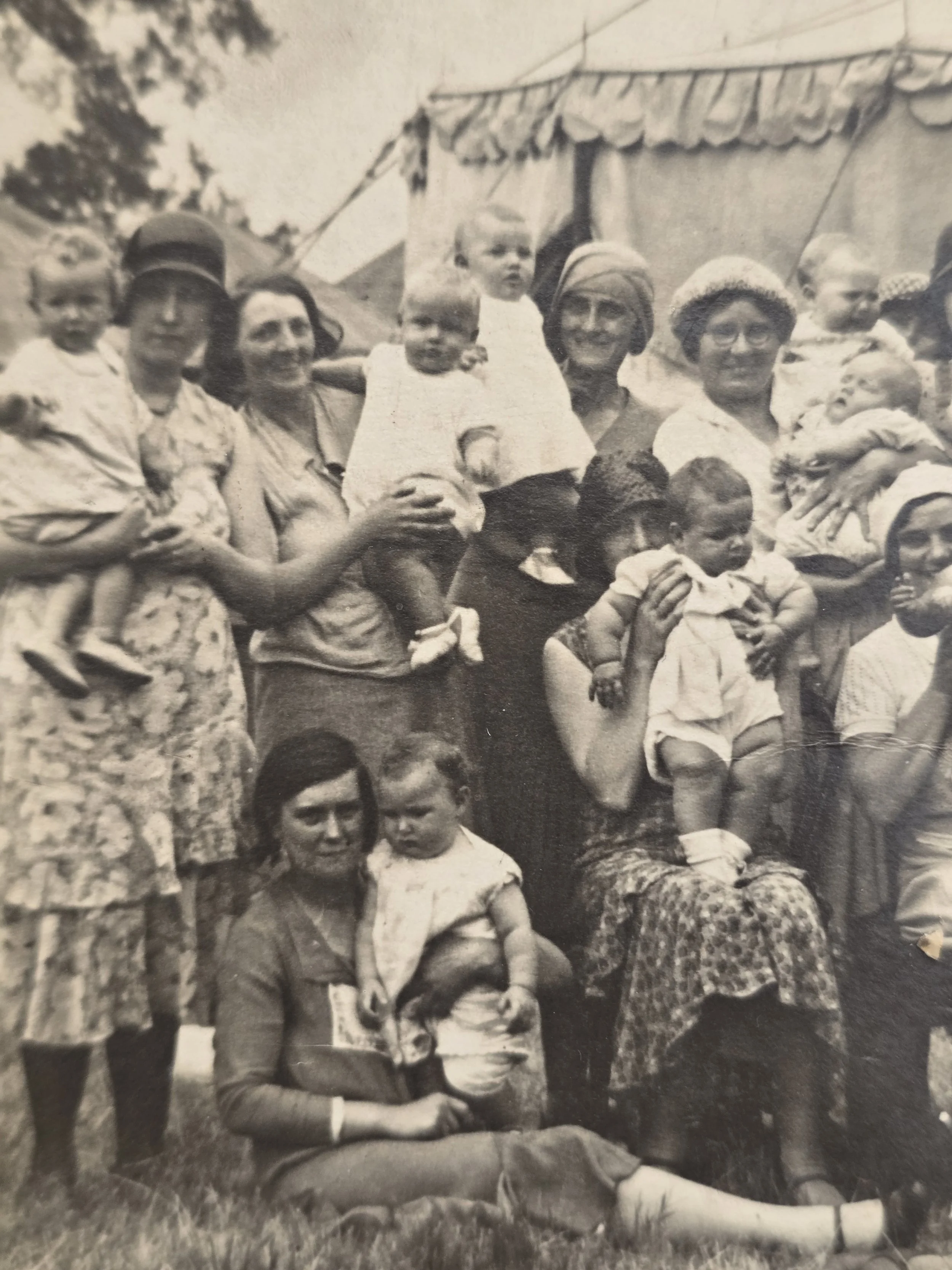 Close-up of women and young children in a possible 1930s travelling circus family photograph.