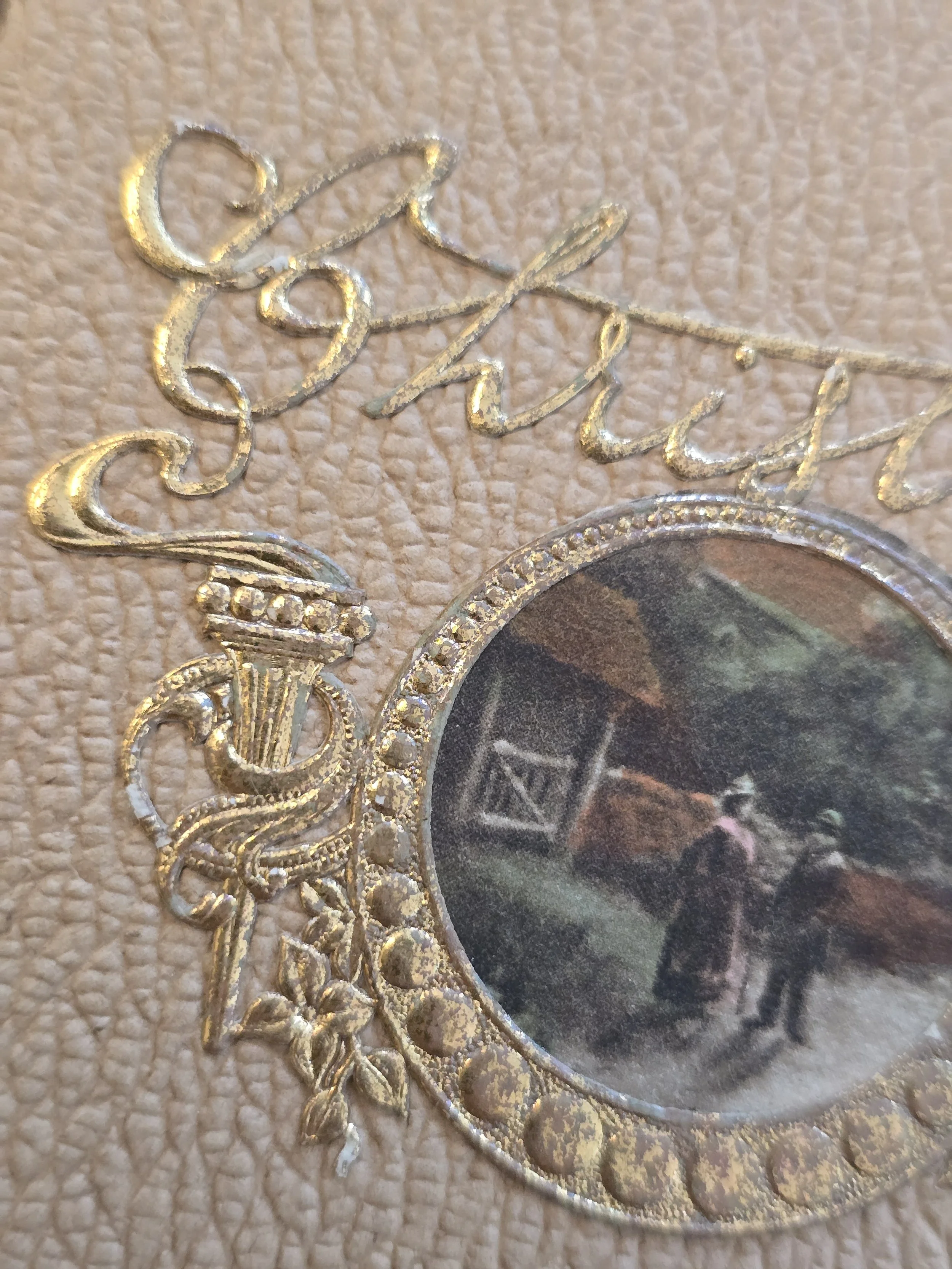 Detail of ornate gilt Christmas lettering and decorative frame on early 20th century French greeting card.