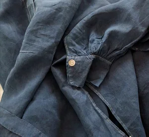 Cuff detail with mother-of-pearl button on French indigo smock.