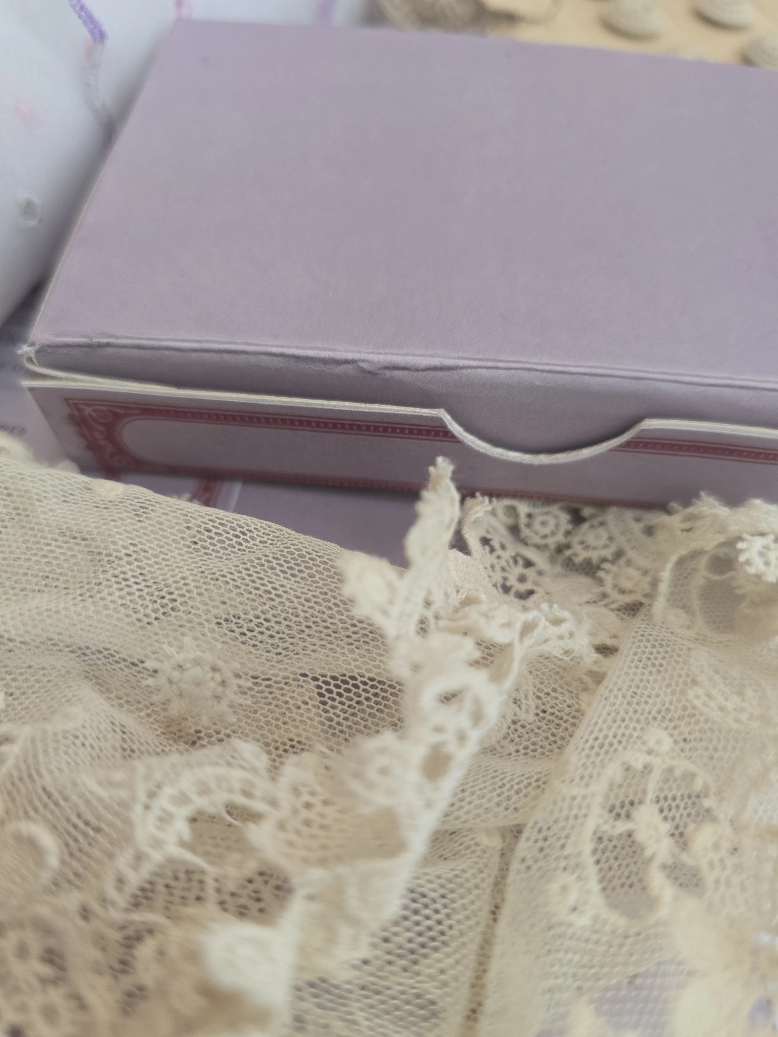Open handmade portrait box with vintage crystal jewellery inside, styled with antique lace, buttons and embroidered textiles