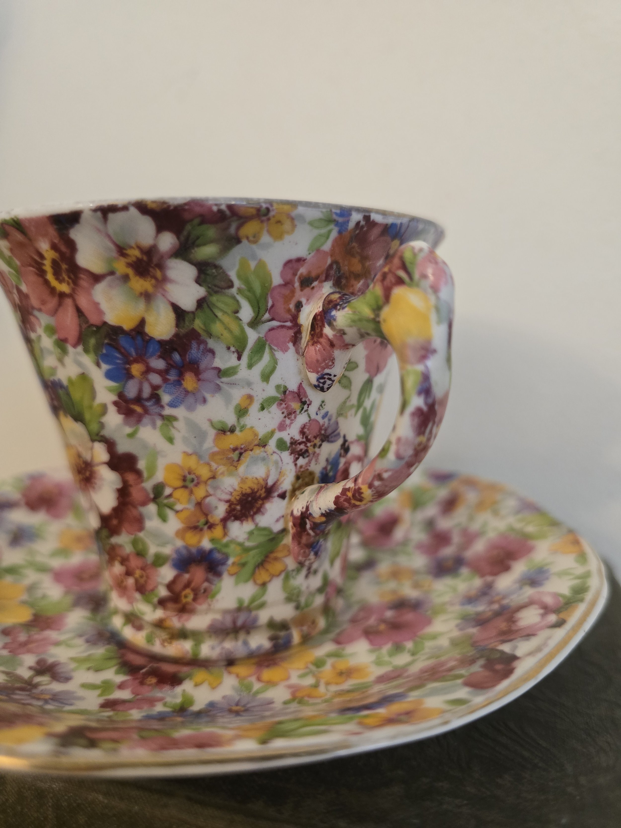 Side detail of vintage Royal Winton floral teacup showing decorative handle and chintz pattern