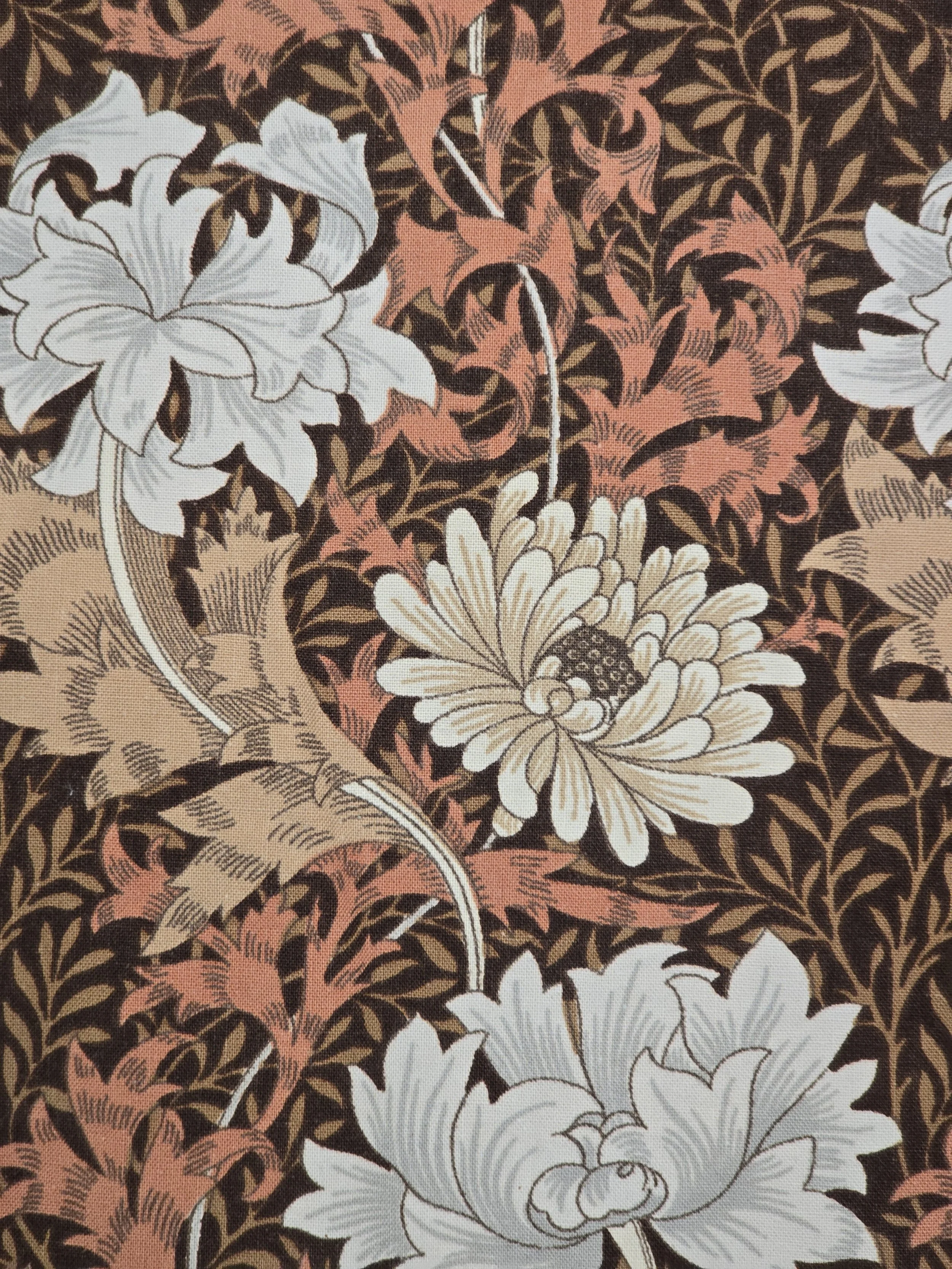 Close-up of William Morris botanical design with cream blooms and foliage.