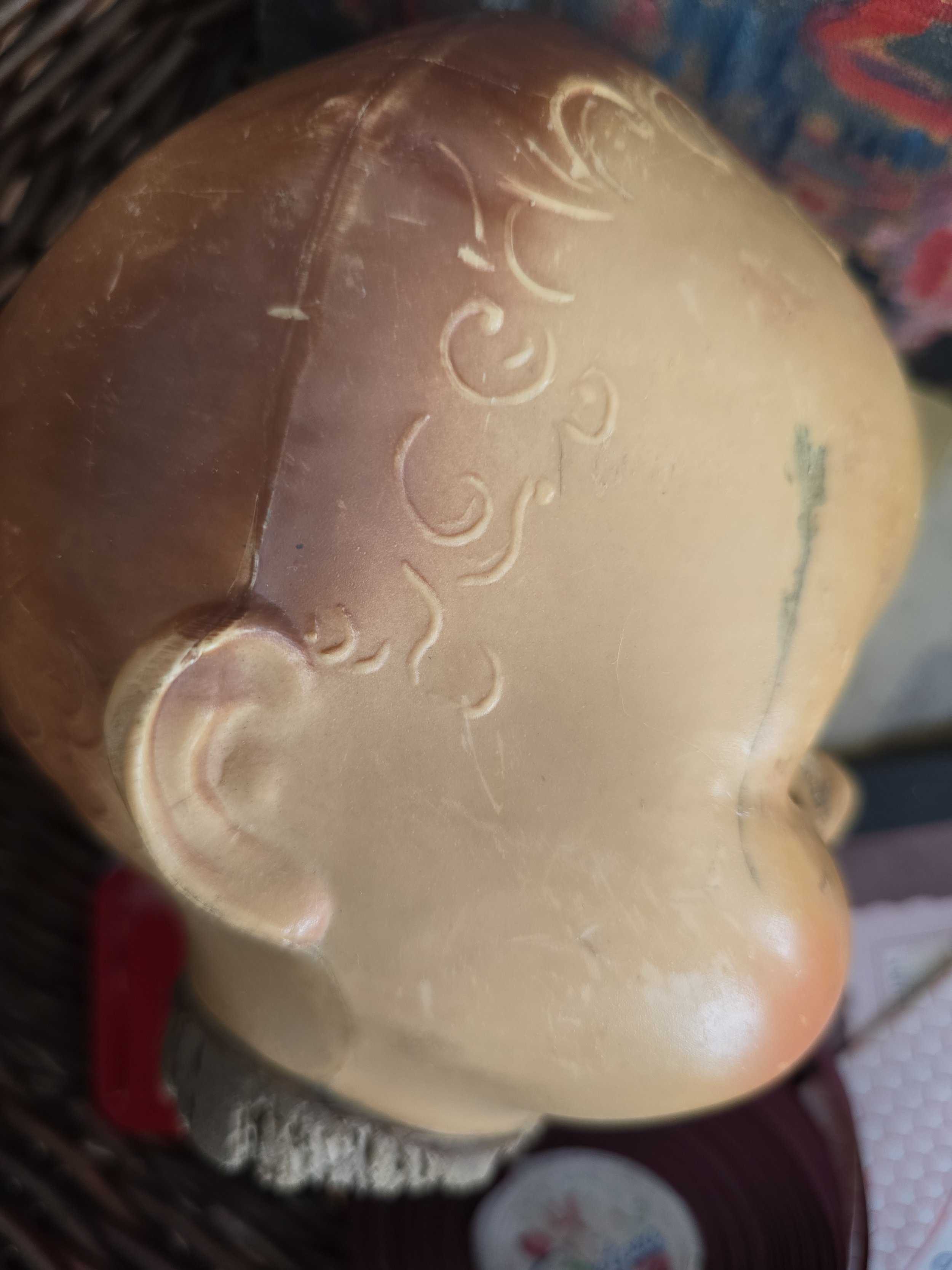 side view of original sleep doll head with aged patina