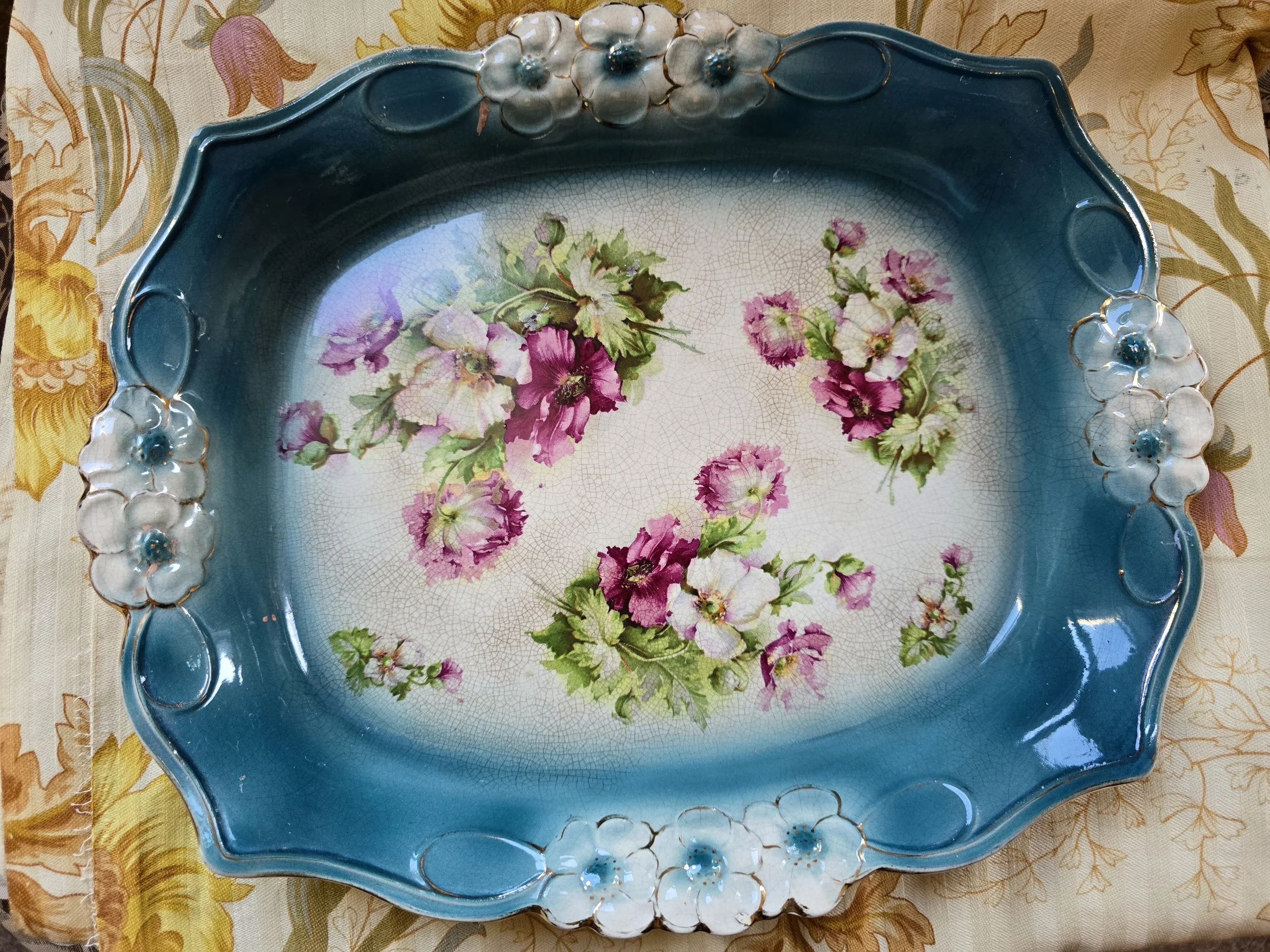 1. Vintage floral ceramic tray with deep petrol blue border, pink flowers and raised white floral decoration.