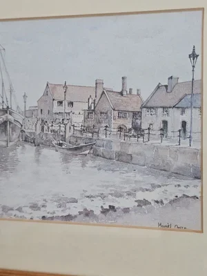 Detail of vintage nautical wall art showing fishing boats on water.