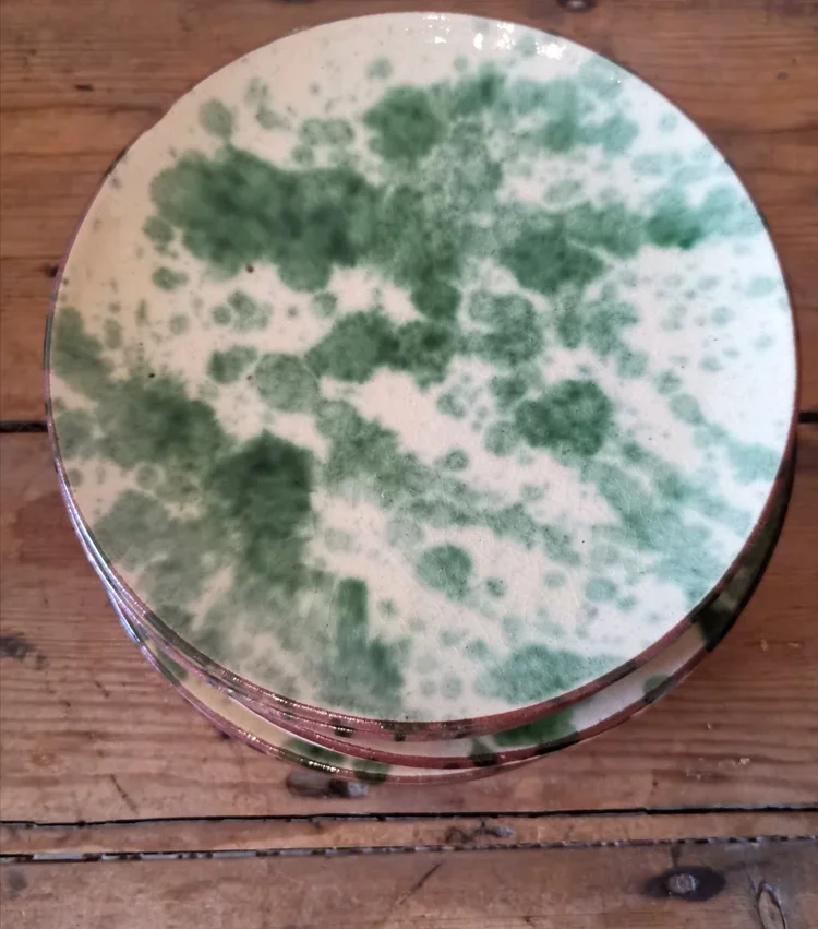 Top view of vintage olive green jaspé glazed French plate