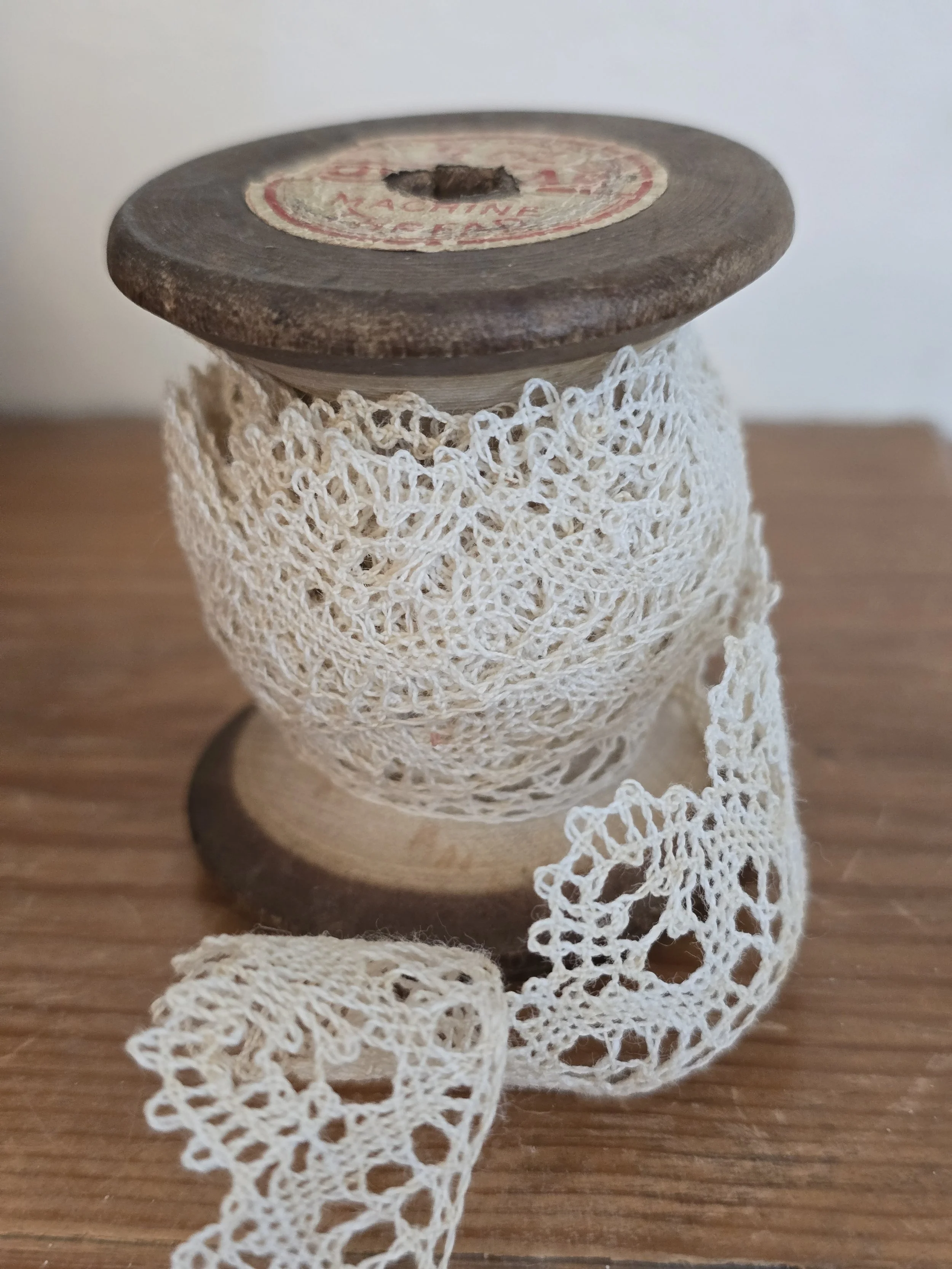 antique thread spool lace detail close