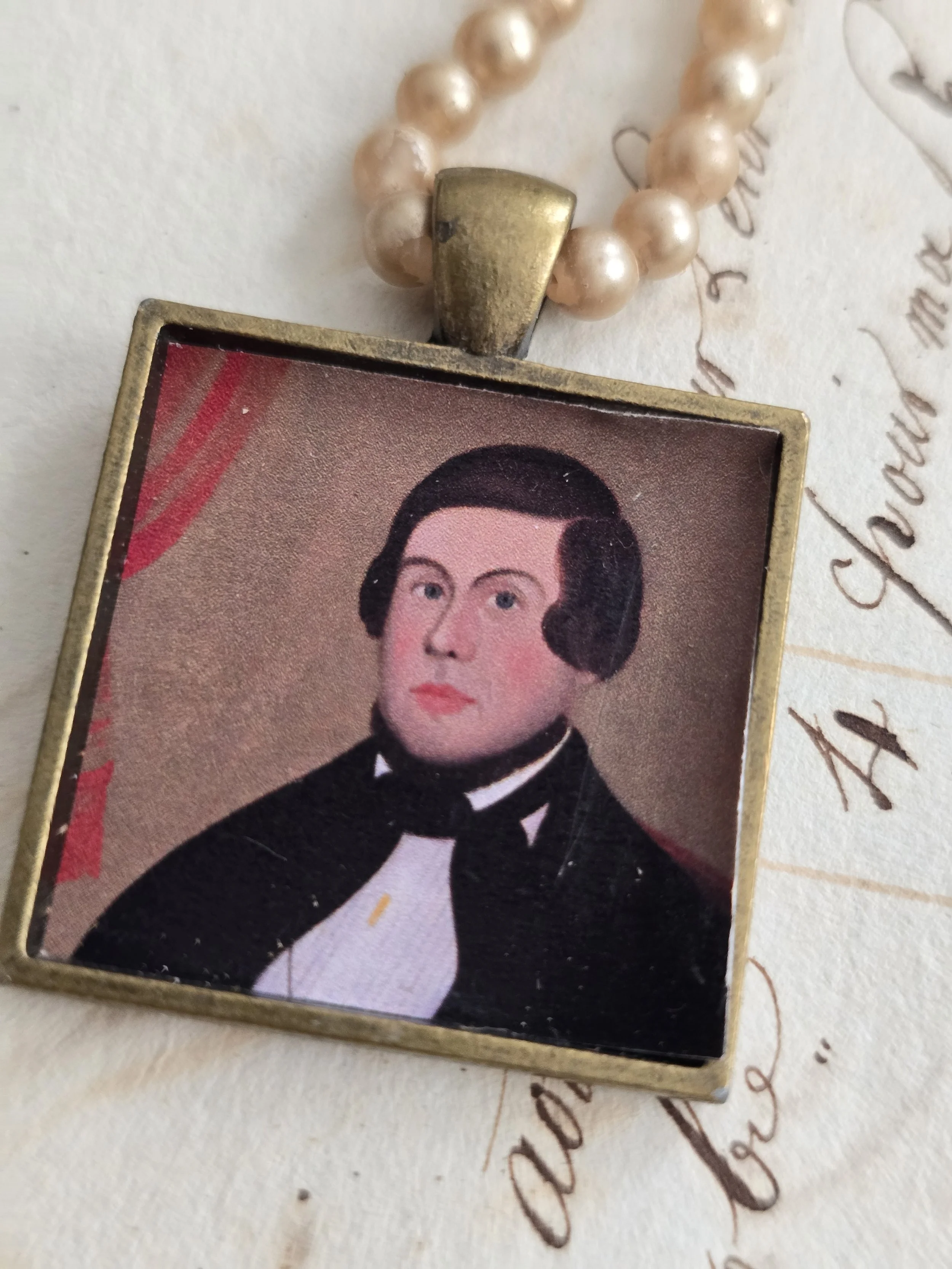 Handmade pendant featuring a 19th century style folk portrait.