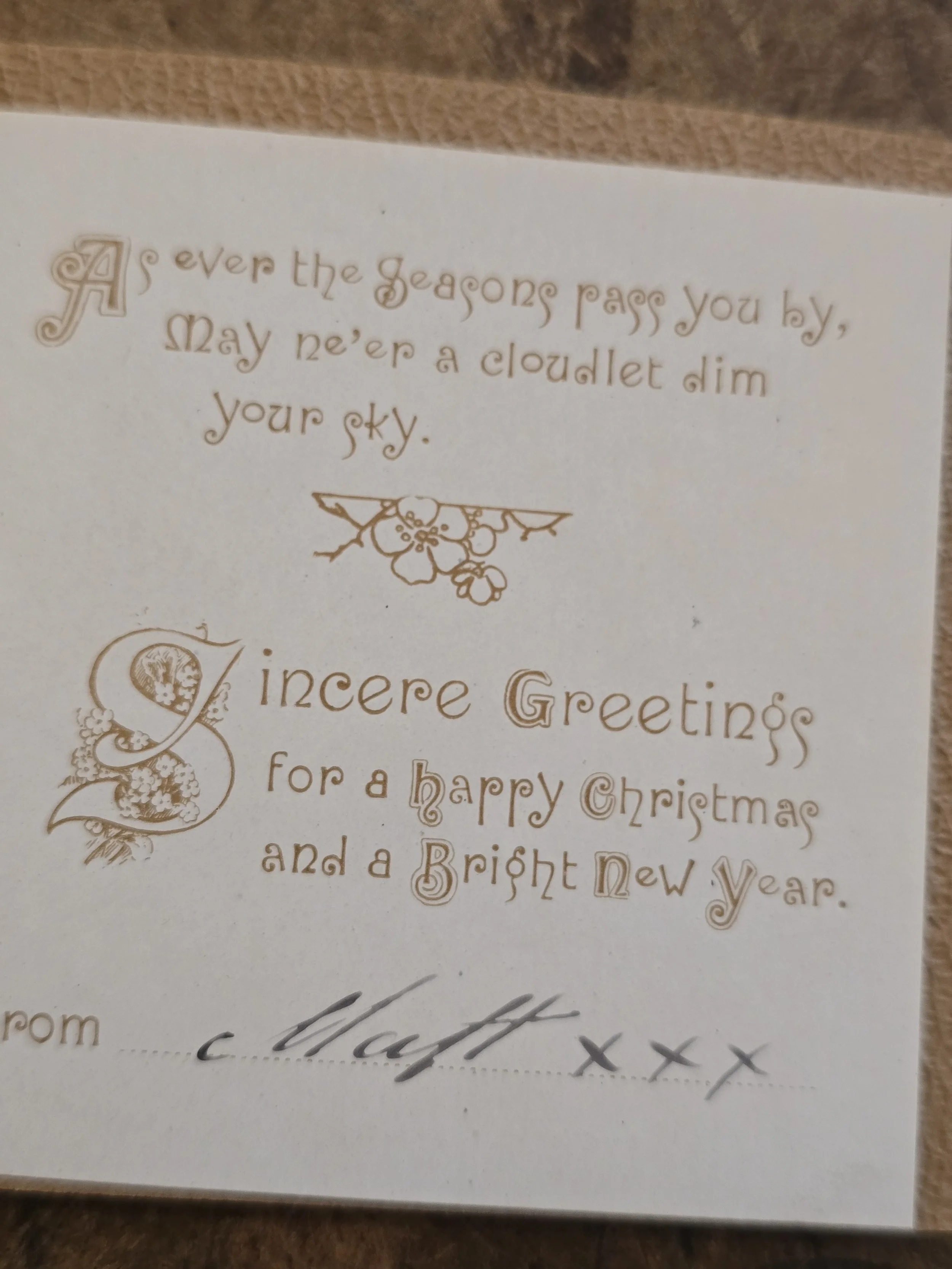 Inside of antique French Christmas card with decorative printed verse, Christmas and New Year greeting and handwritten signature.
