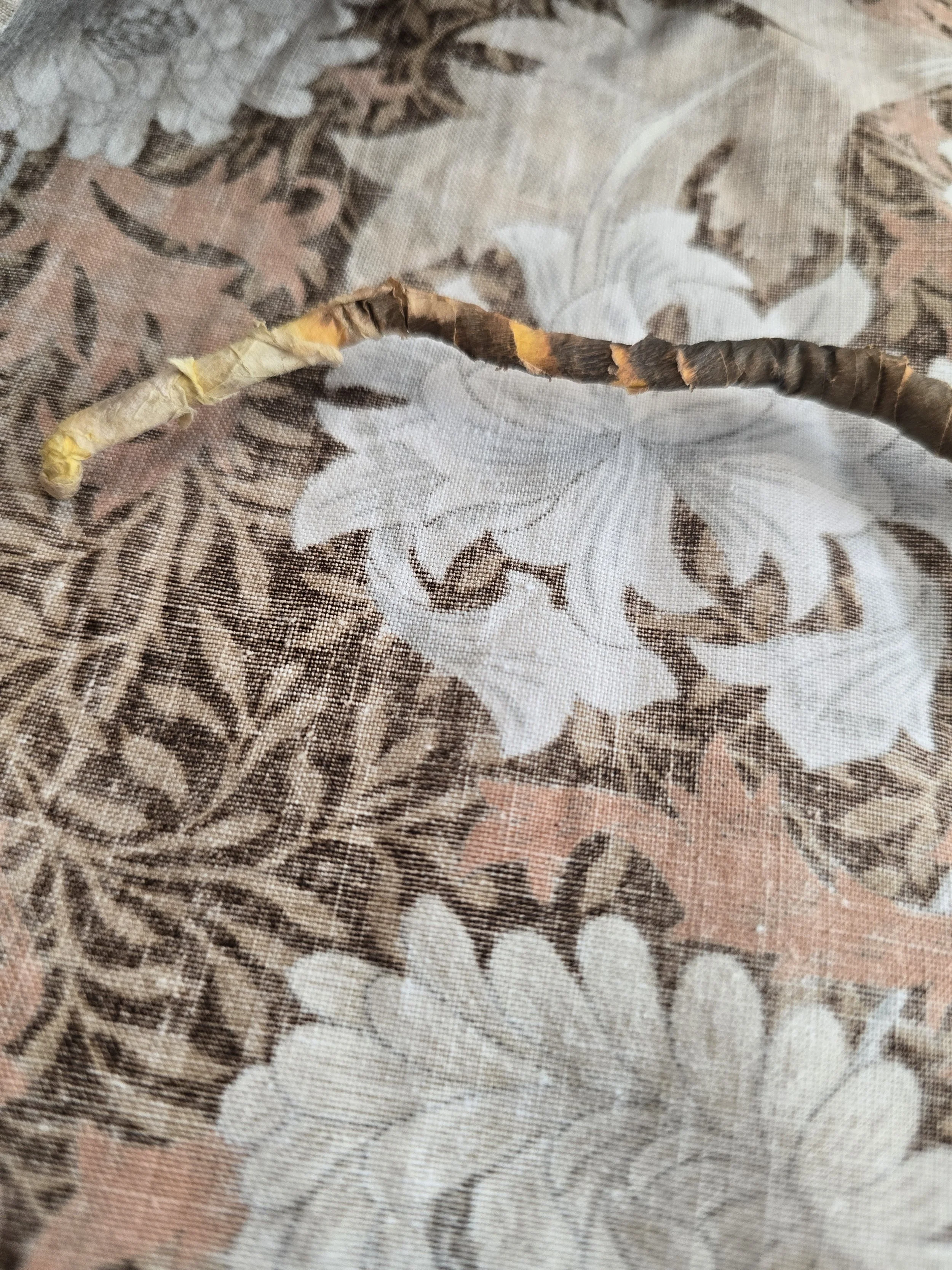 Mid-century decorative floral ornament featuring gold-toned leaves and wrapped stem