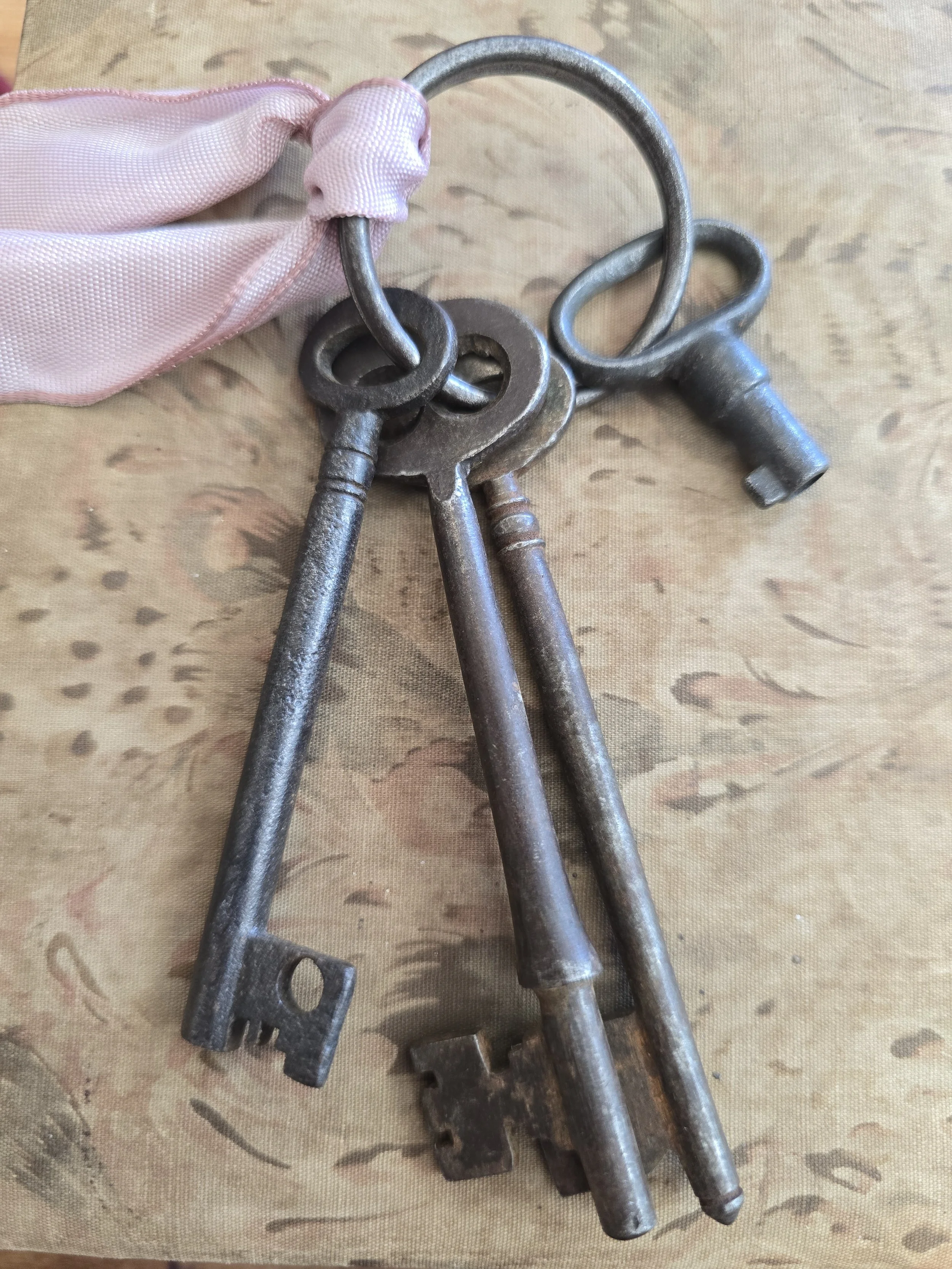 Antique iron keys showing aged patina and wear from use.